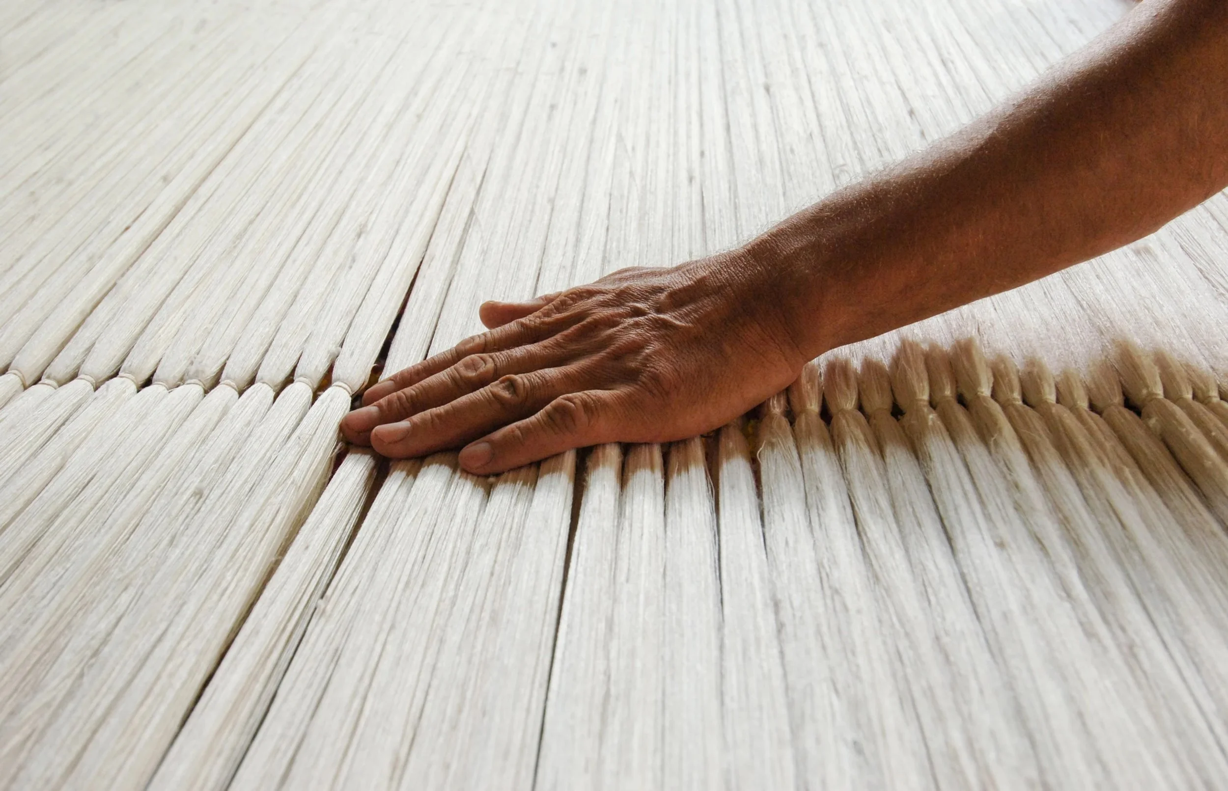 Hand smoothing a textured fabric surface during cleaning or organizing.