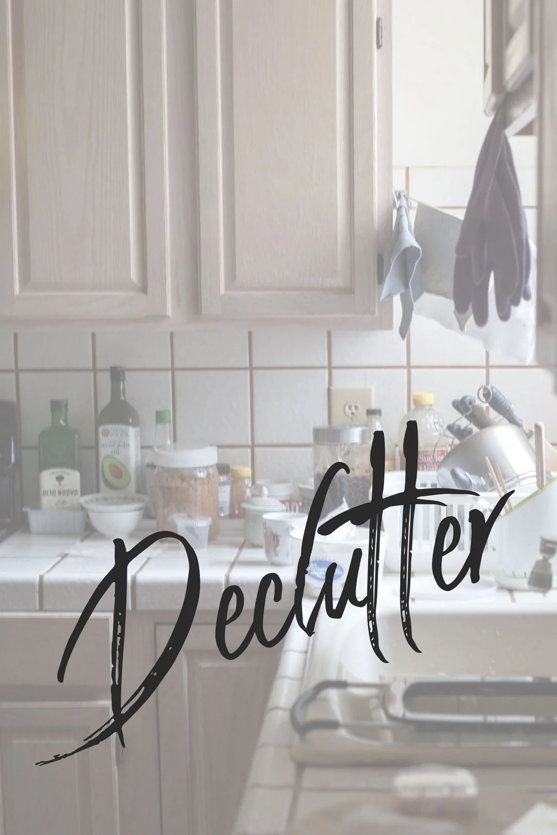 Cluttered kitchen counter with bottles, containers, and dishes during home decluttering.