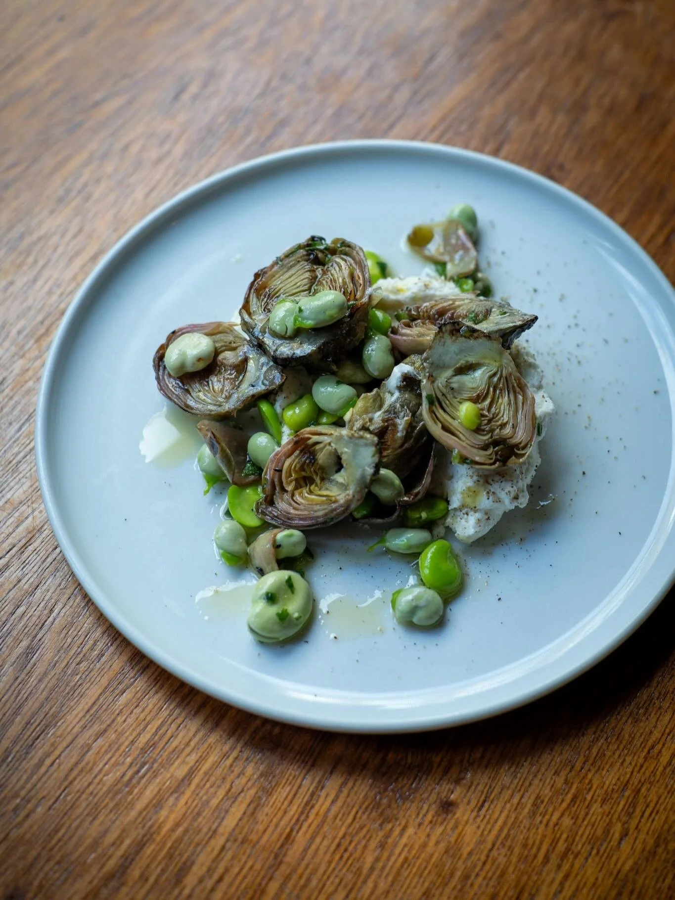 Bringing some spring-like colours and flavours to the table with this wood-grilled artichoke, goat&rsquo;s curd and broad bean dish, and tarte fine of shallots with gorgonzola and pear. ⁠
#artichoke #broadbeans #seasonalcooking #gorgonzola #shallot