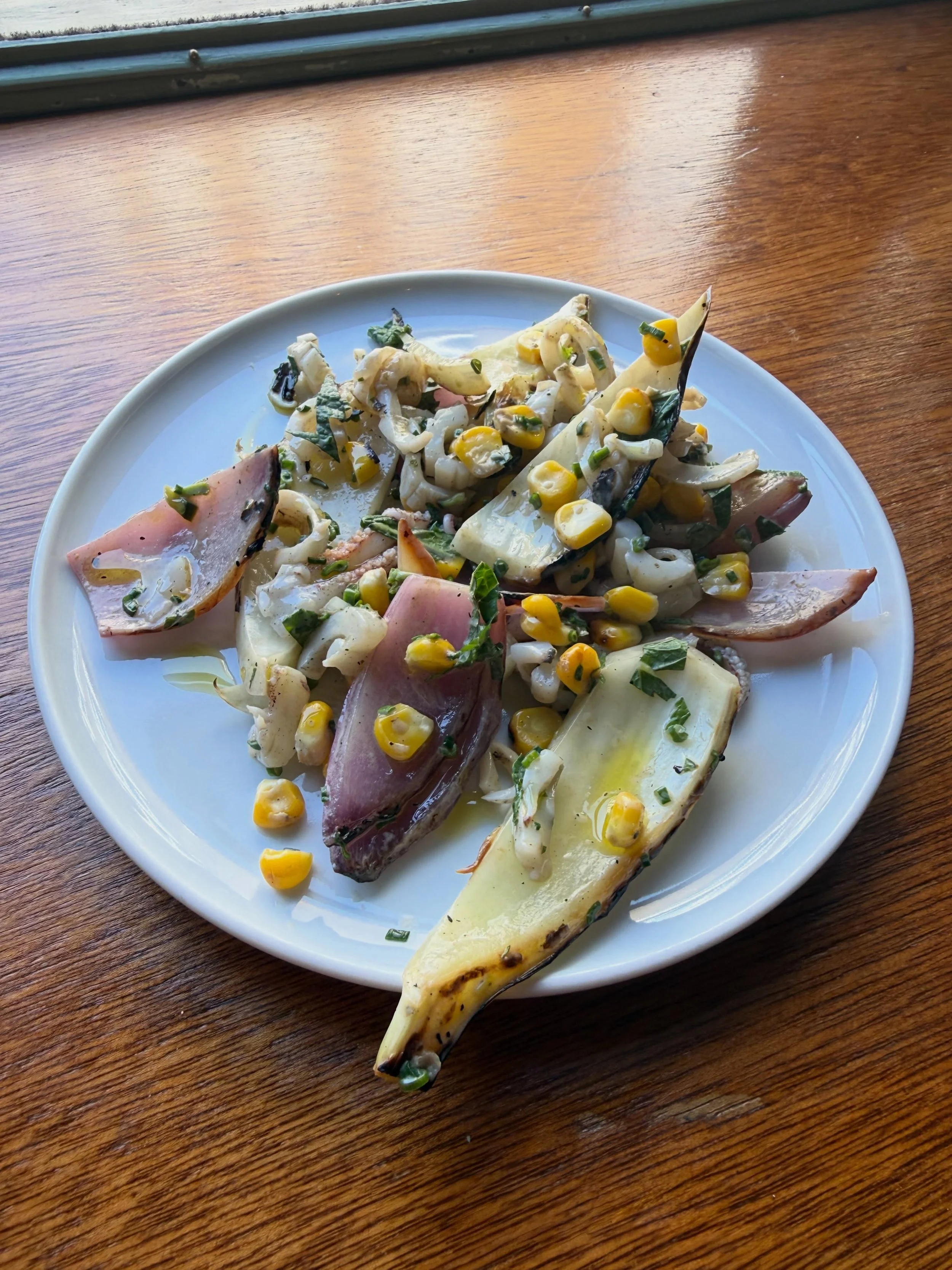 Char-grilled squid, @shrub.london sweetcorn, grilled fennel and breme onions 🧅