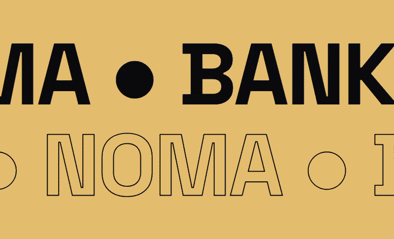 Close-up of text on a beige background, featuring the words 'BANK' and 'NOMA' with decorative dots.