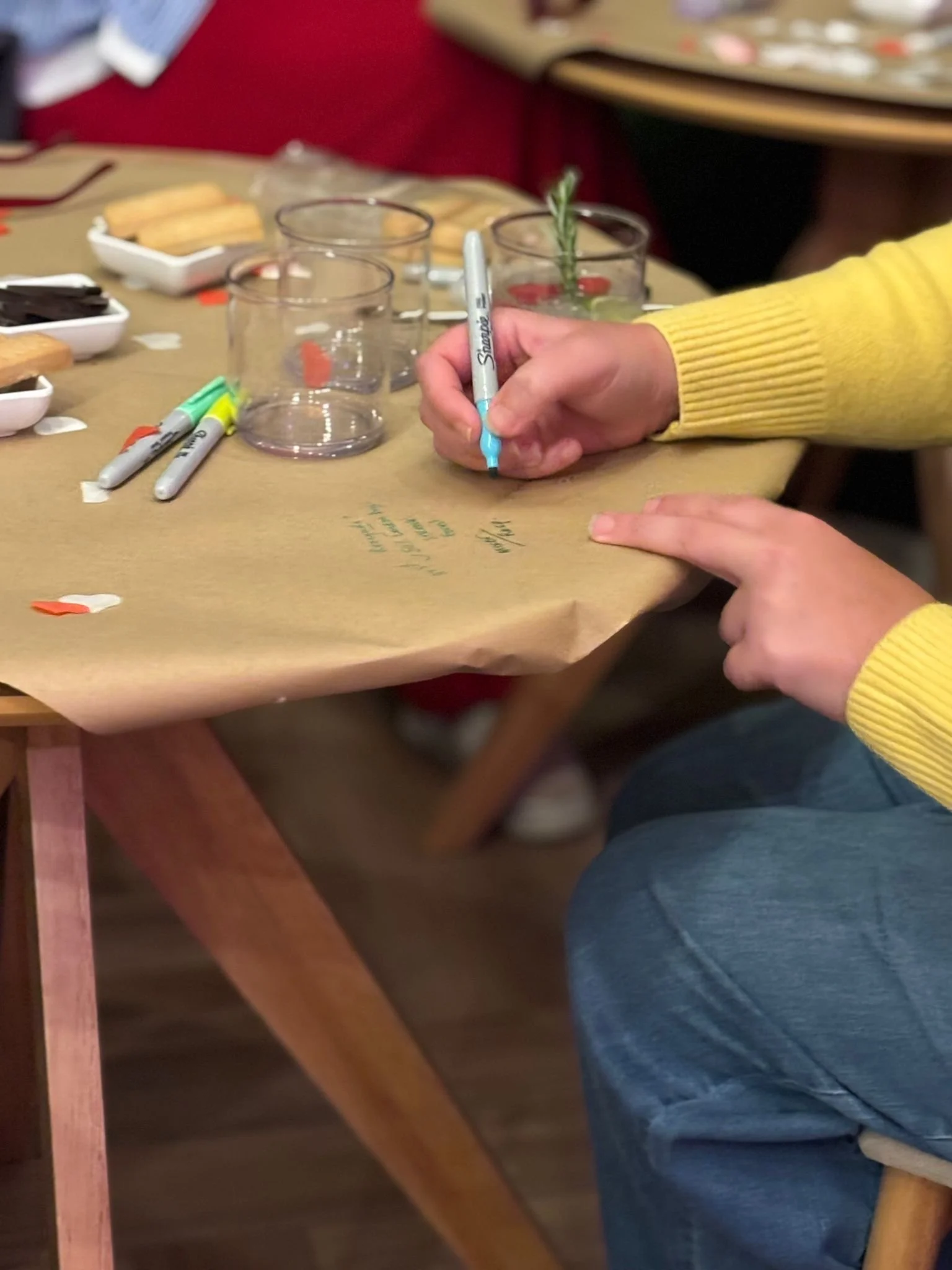 Gin sensory experience in Cullen, Moray, Scotland. Writing on a table tasting notes about the gin she's trying.