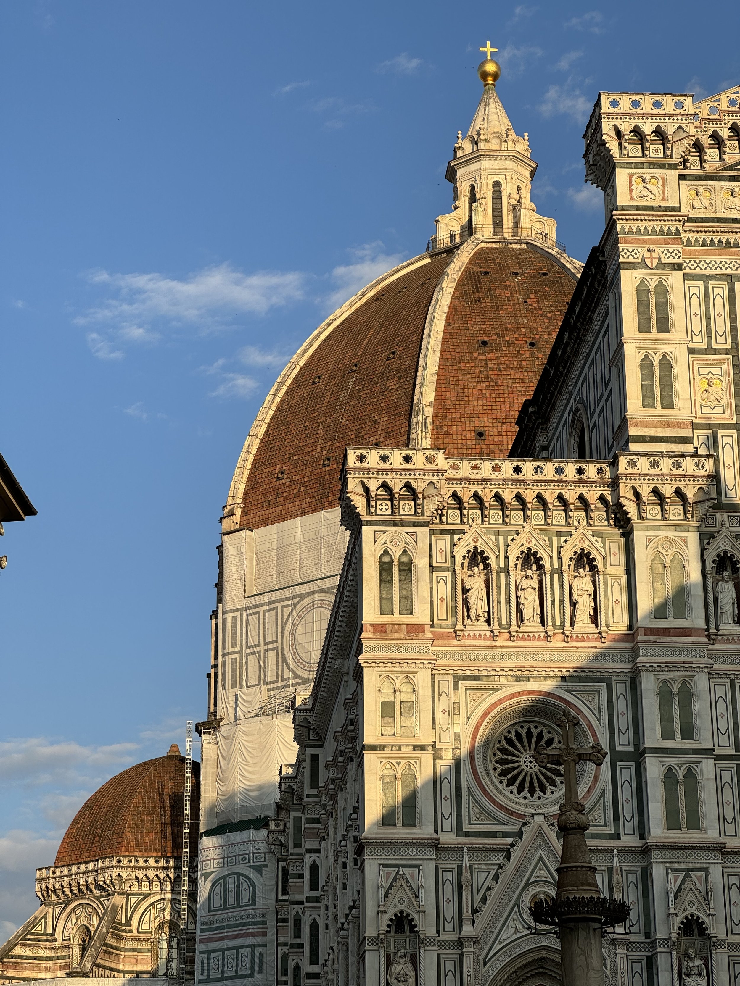 Florence Cathedral with Brunelleschi's Dome, Italy, in sunlight with blue sky.