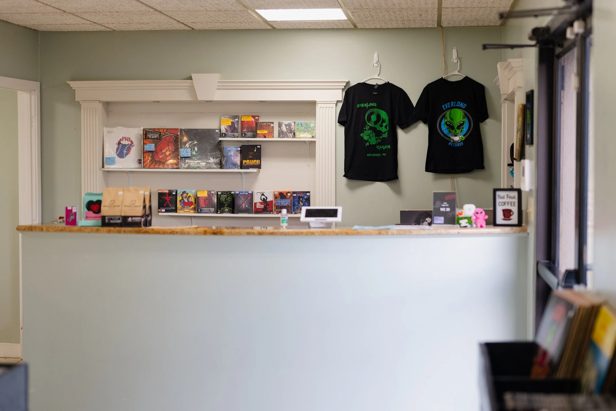 A retail space filled with vinyl records, coffee and merch