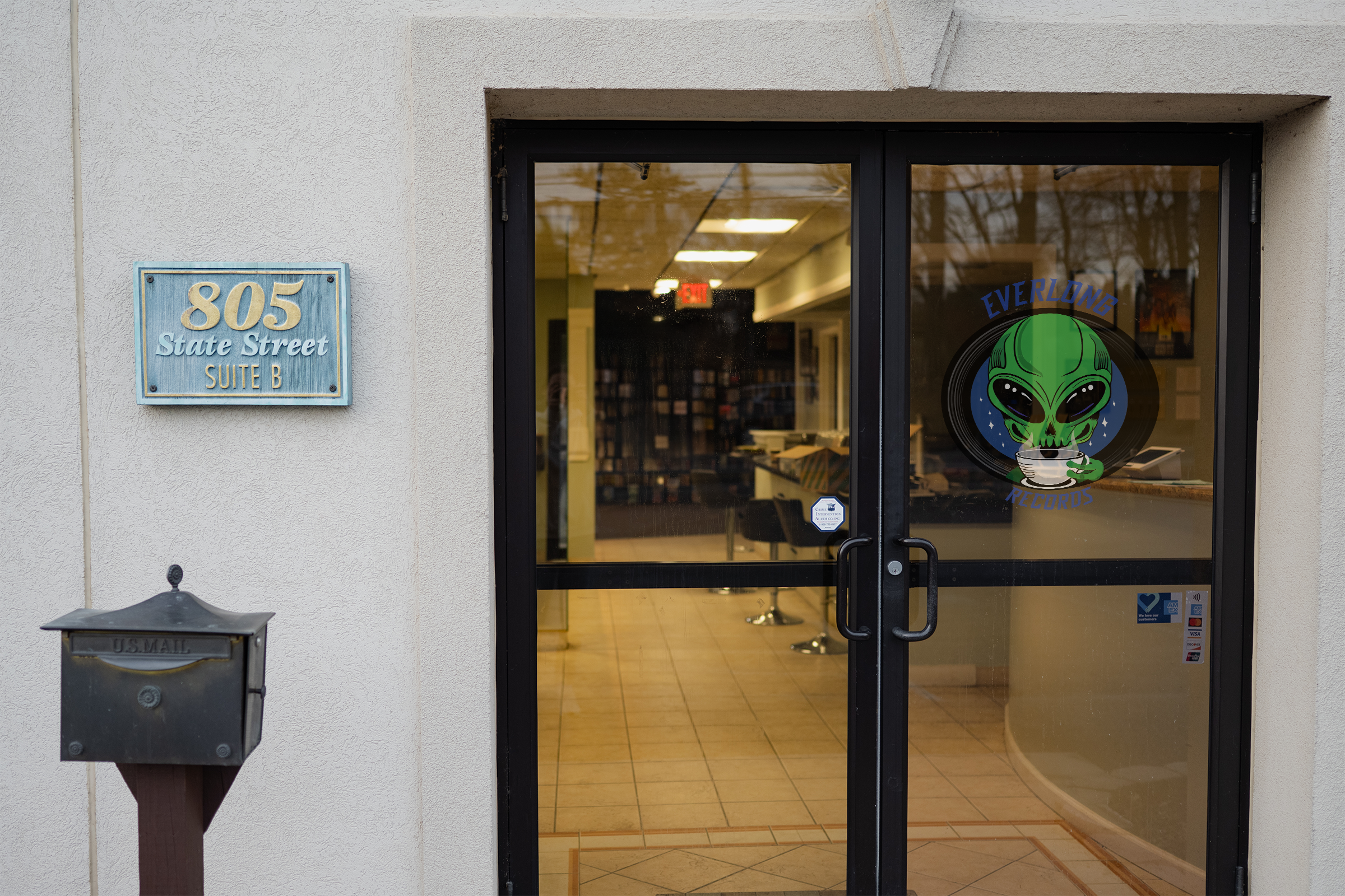Entrance of a business at '805 State Street, Suite B' with signage of an alien logo and 'Everlong Records' on the glass door.