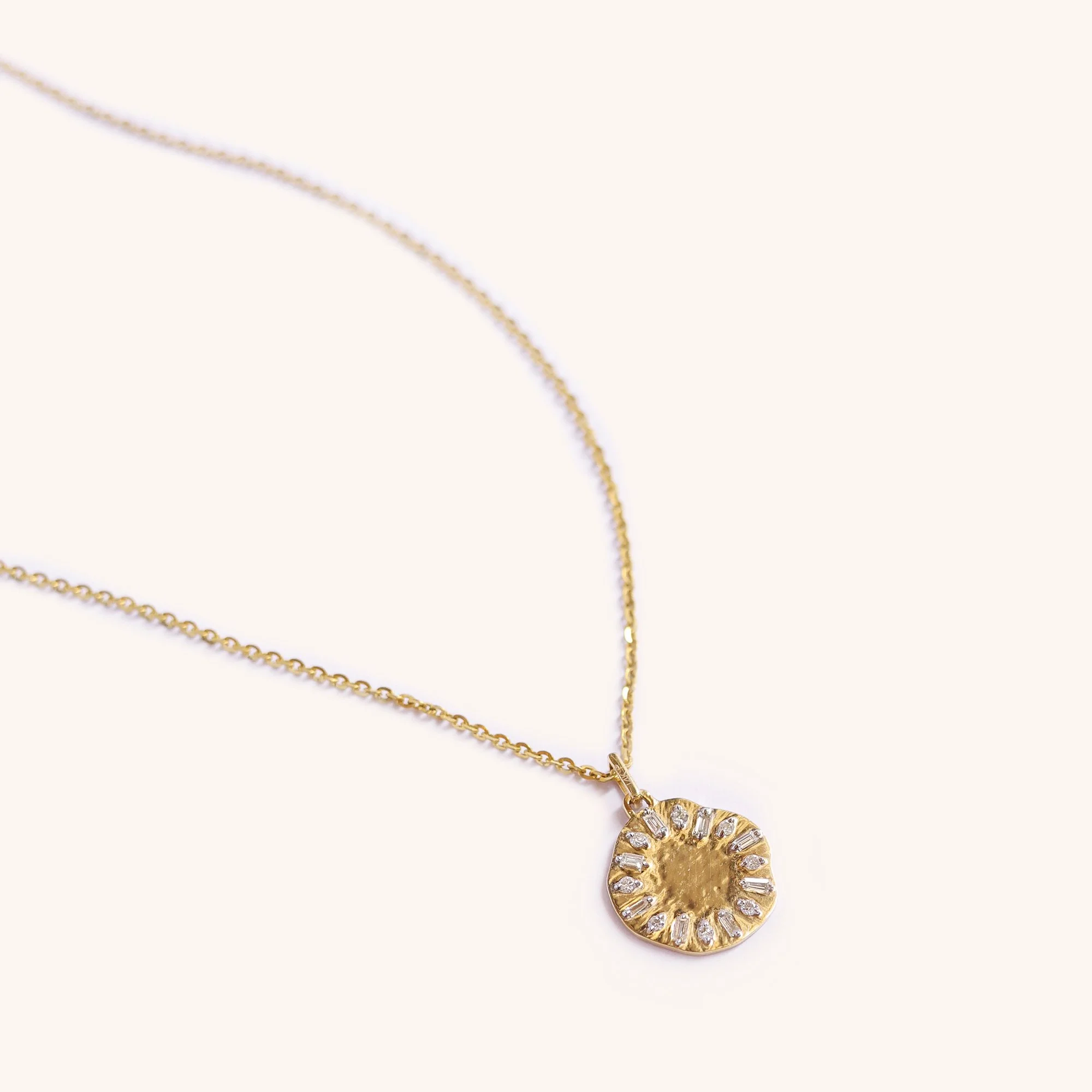 Eclipse Clock Medallion Necklace featuring a mis-shaped gold pendant with emerald-cut diamonds, shaped like a clock face, displayed on neutral background.
