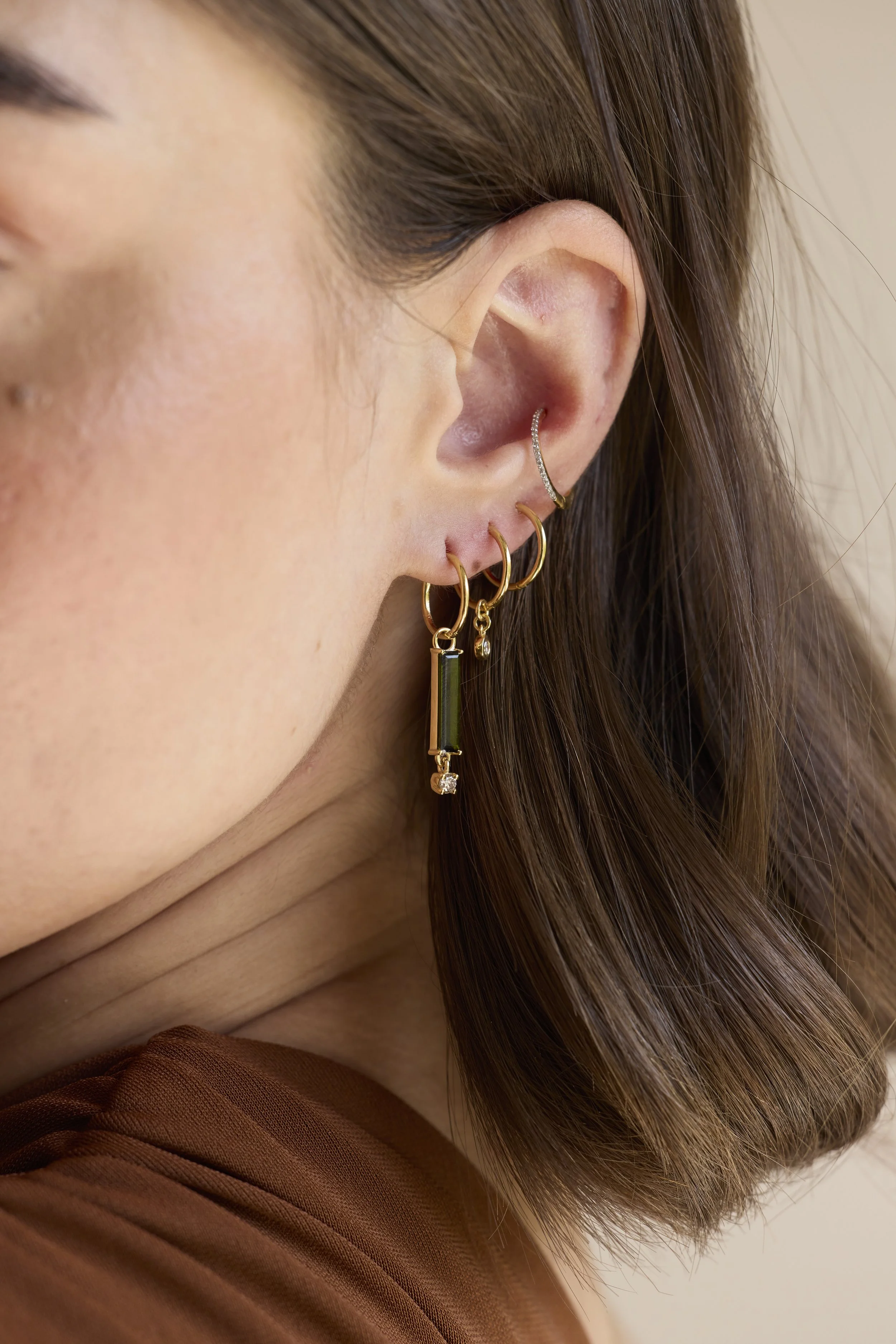 14K Solid gold hoops with diamonds featuring hand-cut diamonds by Zikr Fine Jewelry.