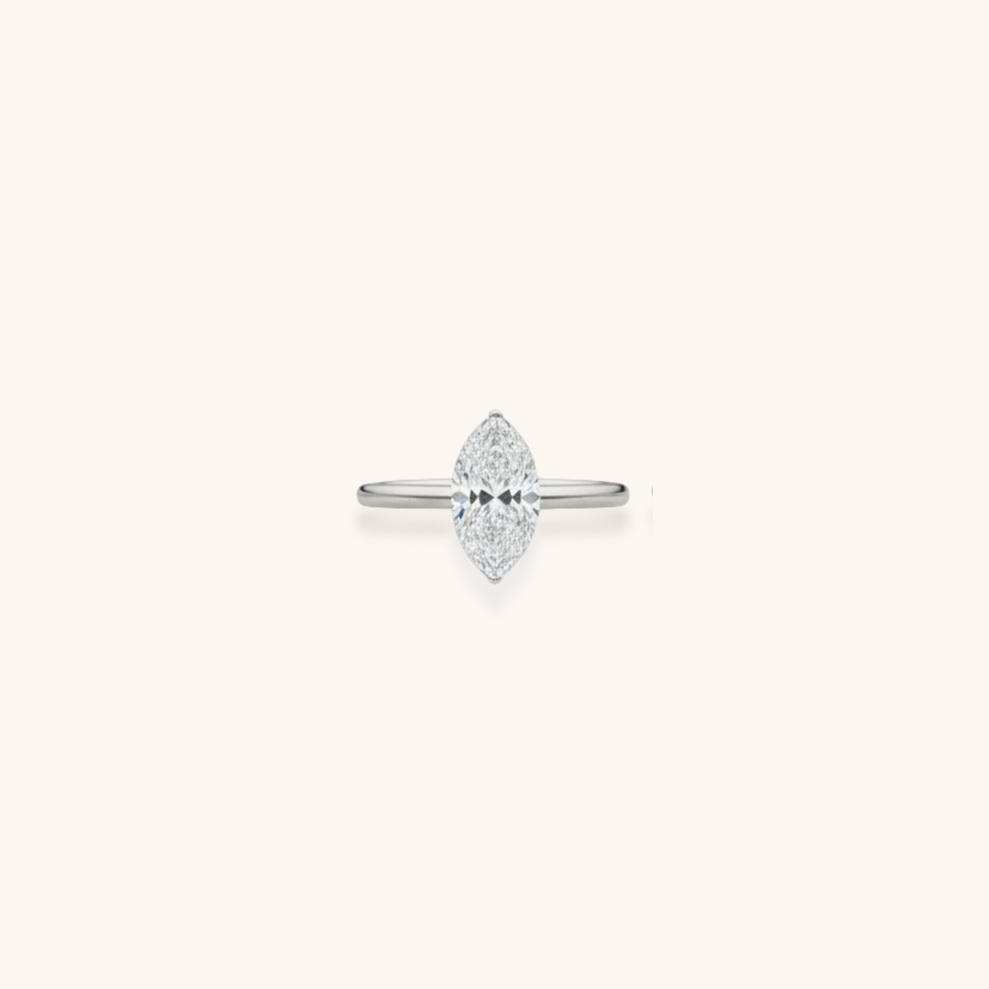 A silver ring with an elongated, marquise-shaped diamond setting on a plain, light background.