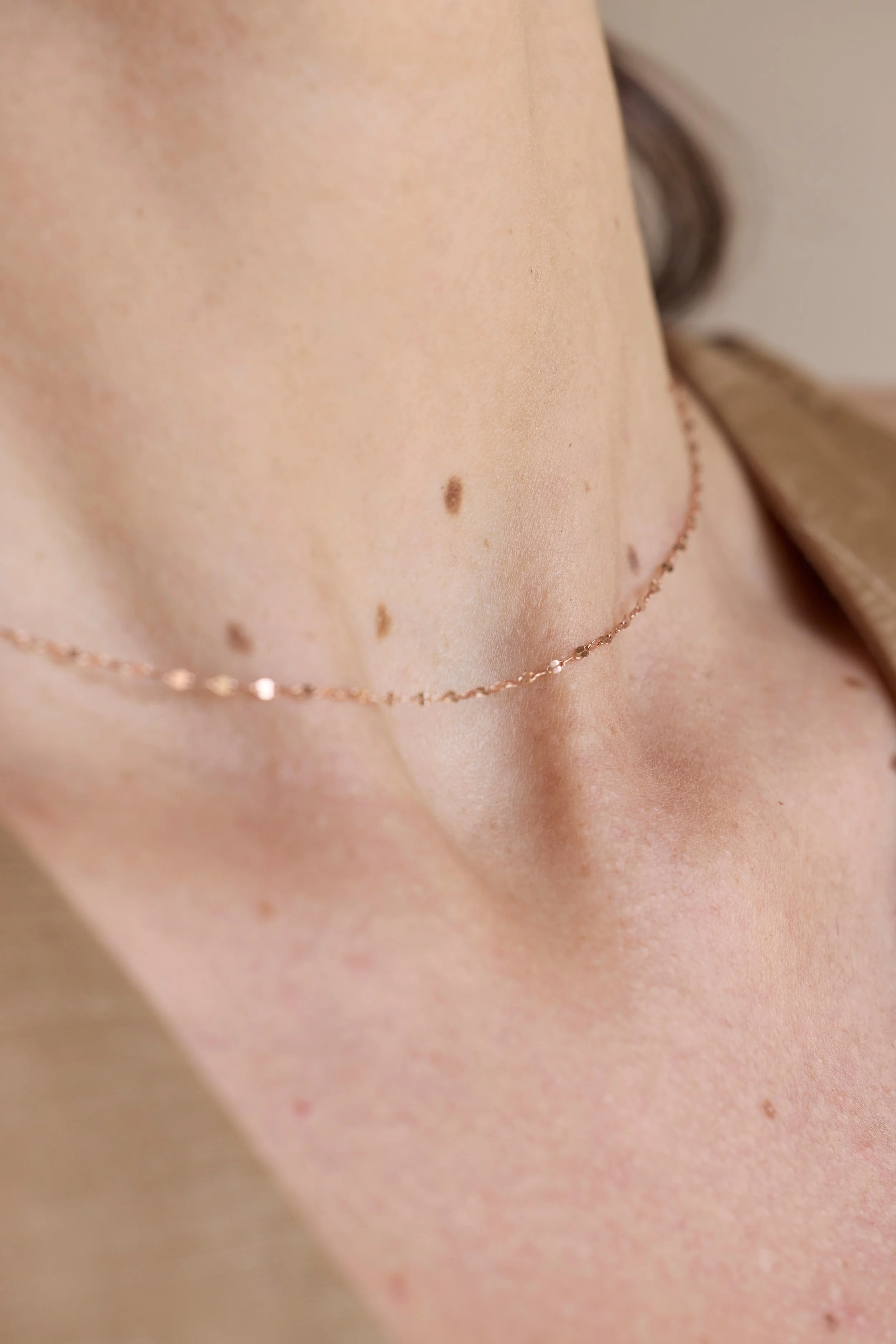 Close-up of 18K rose gold links, minimalist chain necklace for charms.