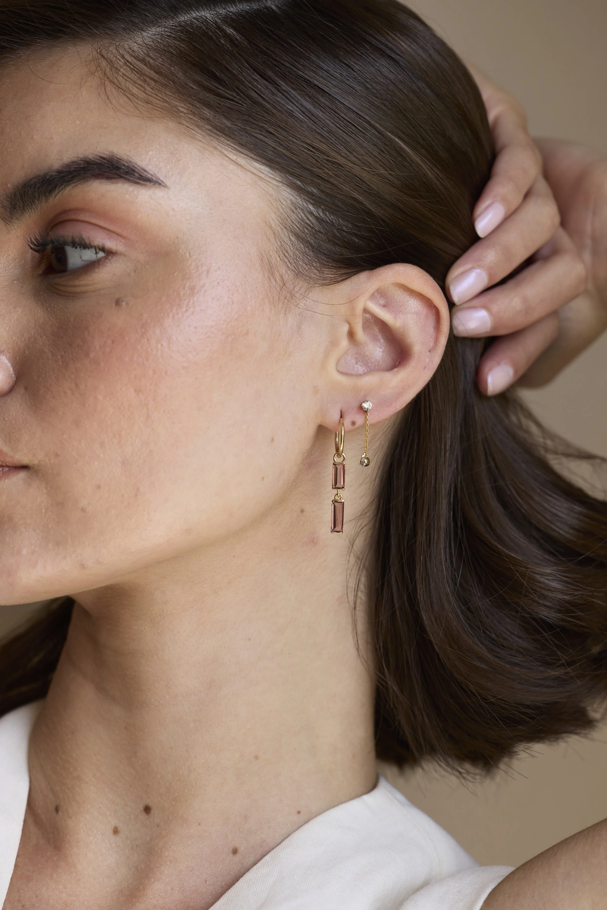 Model wearing 14K gold pink tourmaline drop earrings, elegant feminine gemstone jewelry glowing with soft blush tones.