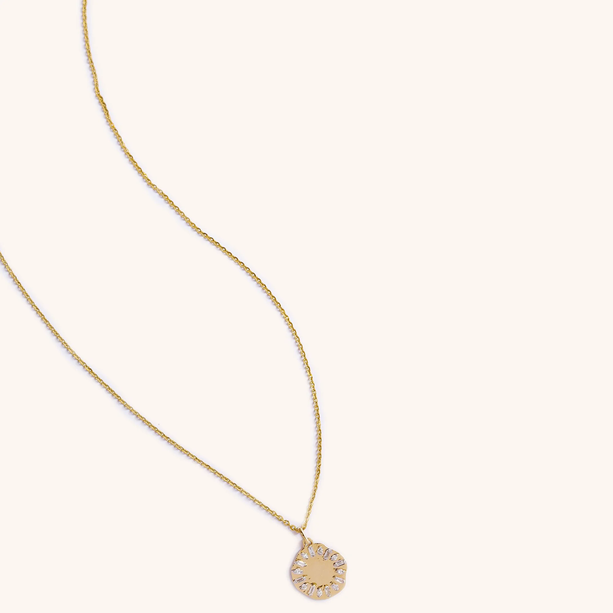 Eclipse Clock Medallion Necklace featuring a mis-shaped gold pendant with emerald-cut diamonds, shaped like a clock face, displayed on neutral background.
