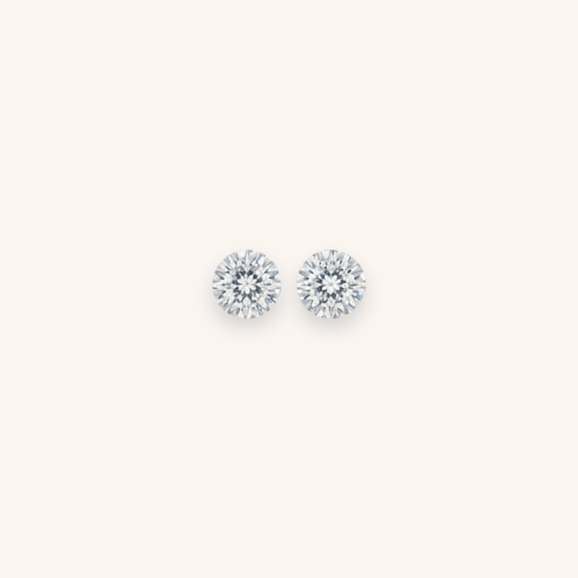 Pair of round diamond stud earrings on a white background.