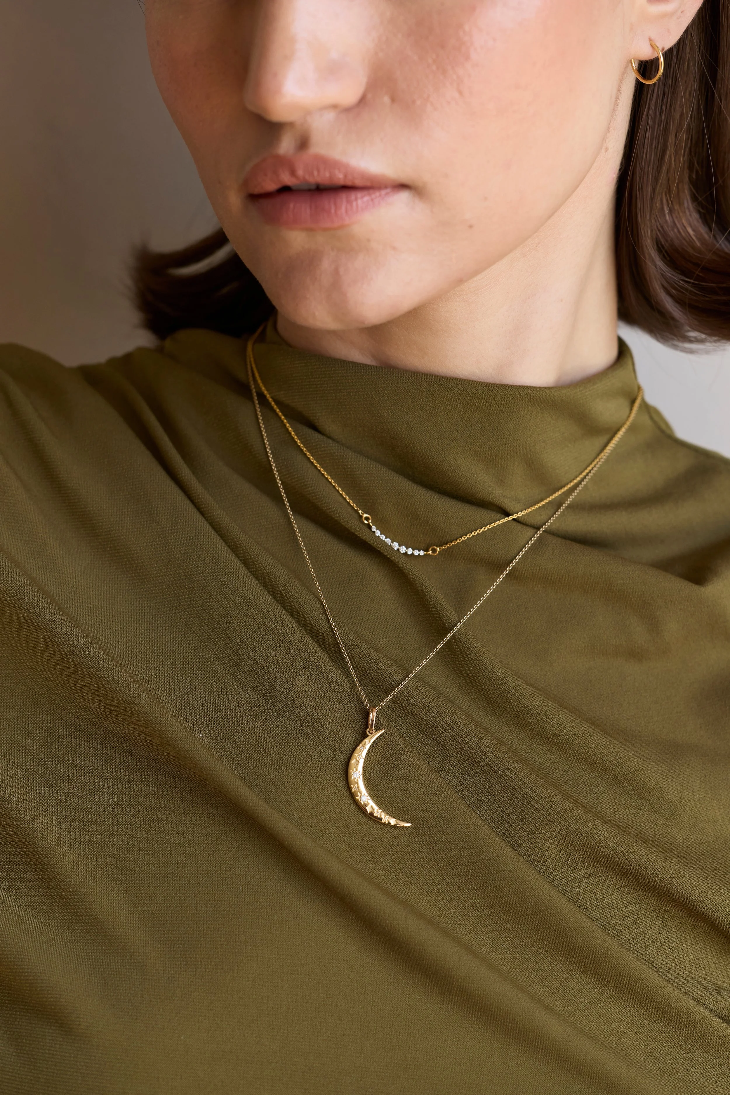 Model wearing diamond crescent moon necklace in 14K gold, elegant jewelry.
