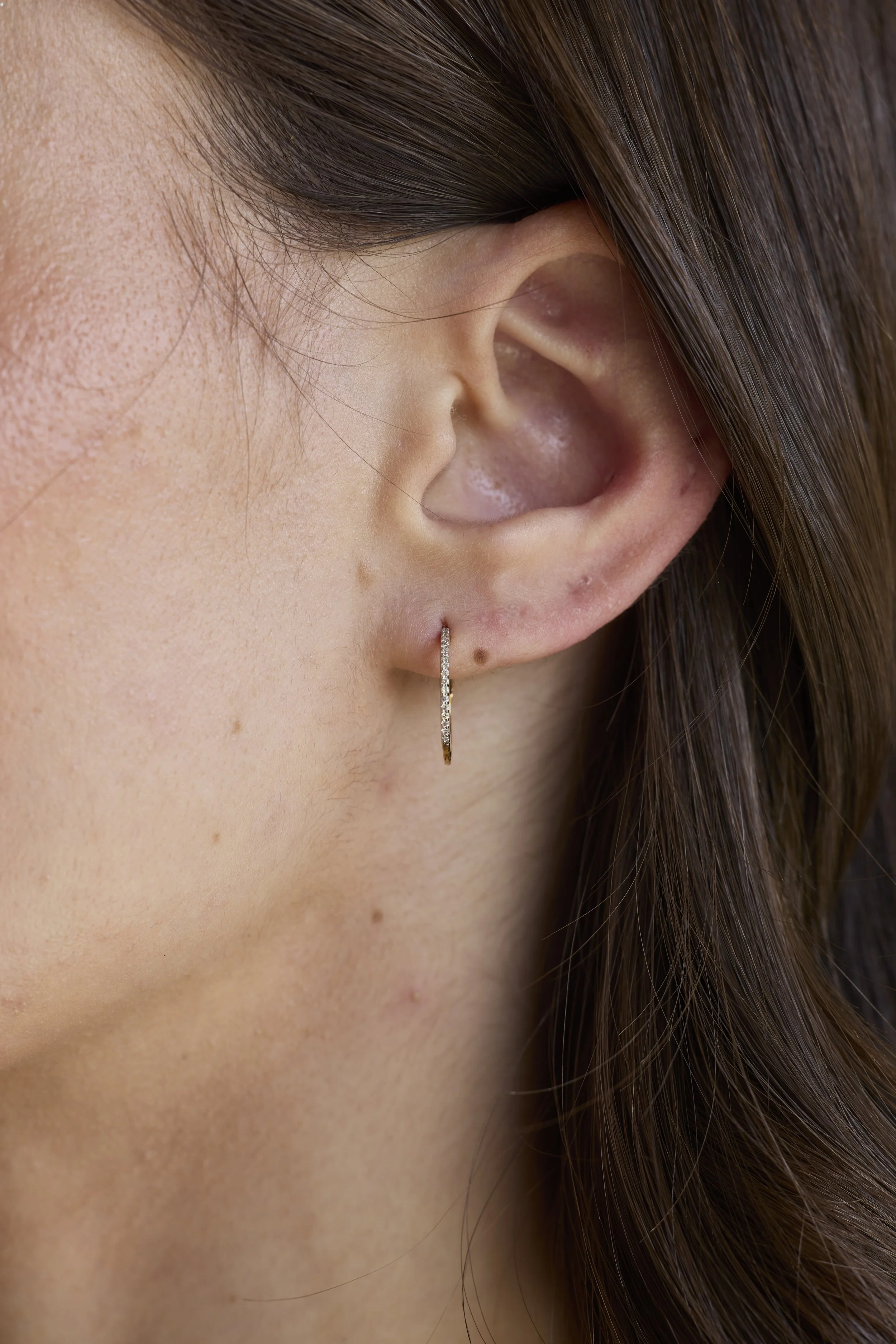 14K Solid gold hoops with diamonds featuring hand-cut diamonds by Zikr Fine Jewelry.