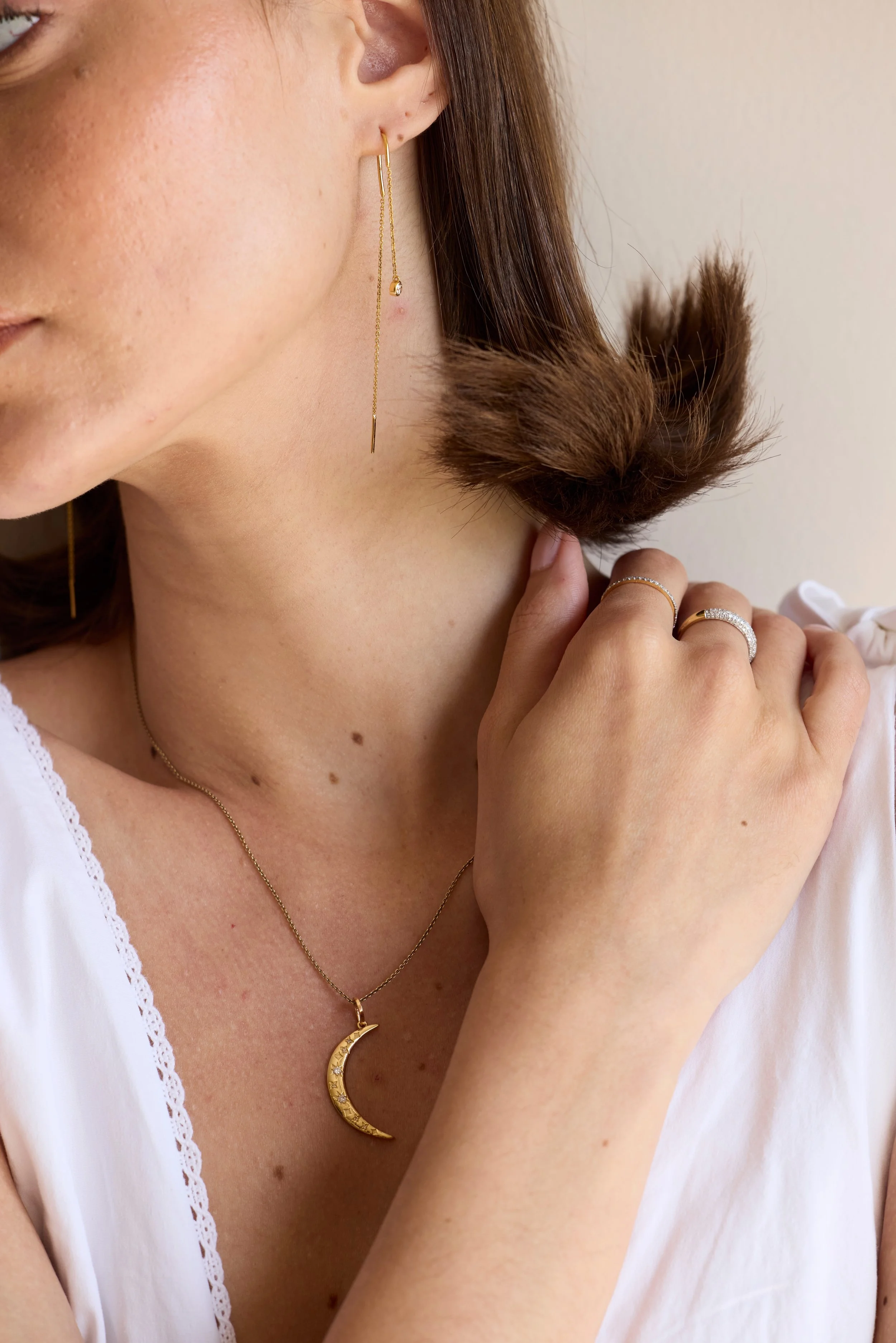 Woman wearing 14K recycled gold rings and a natural diamond pendant — Zikr Fine Jewelry, Toronto, Canada