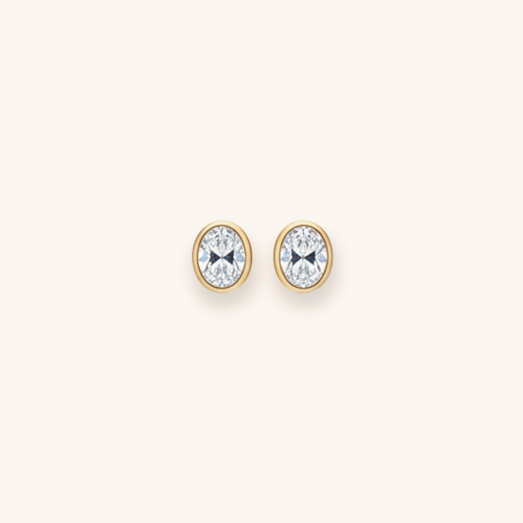 Diamond and gold butterfly stud earrings on a plain background.