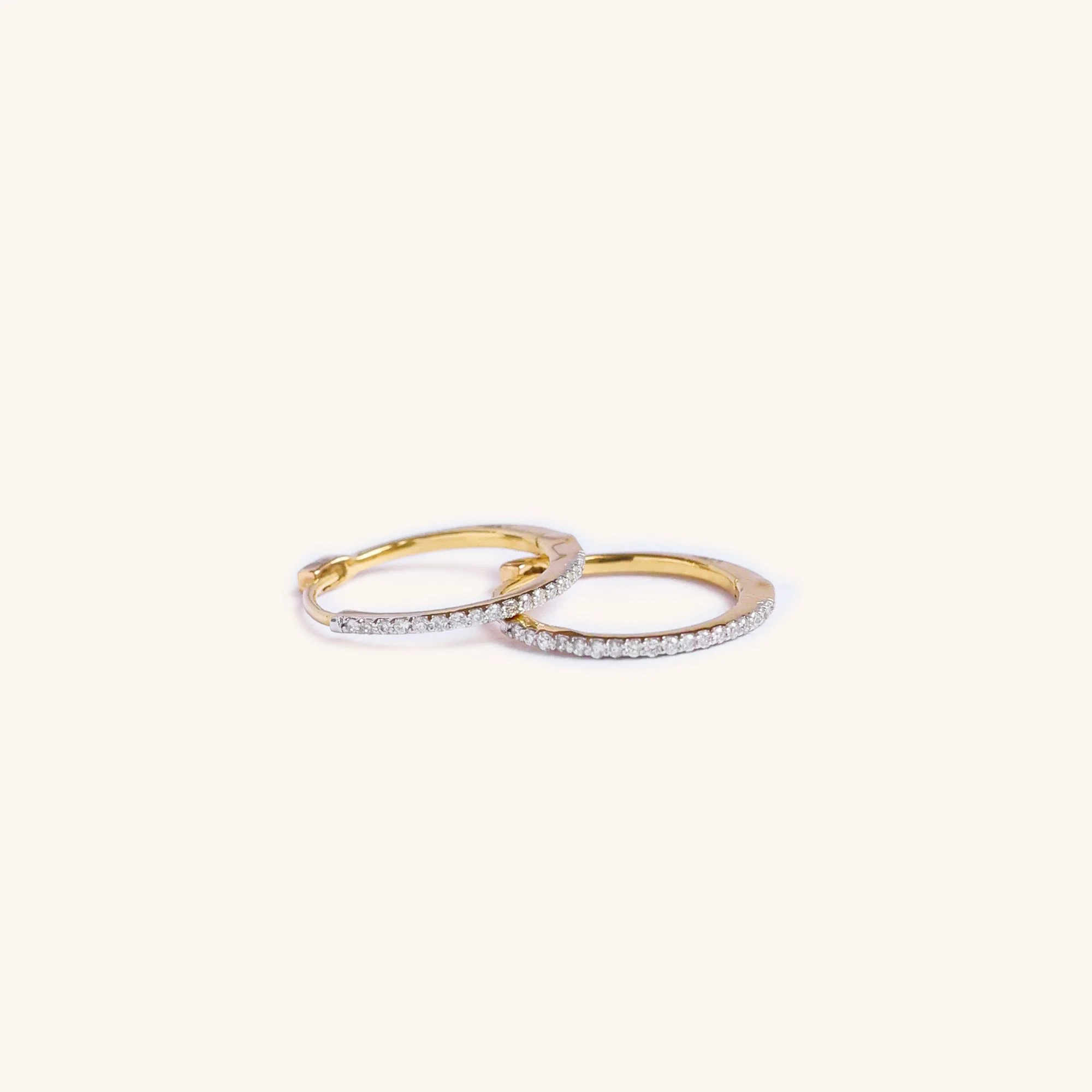 14K Solid gold hoops with diamonds featuring hand-cut diamonds by Zikr Fine Jewelry.