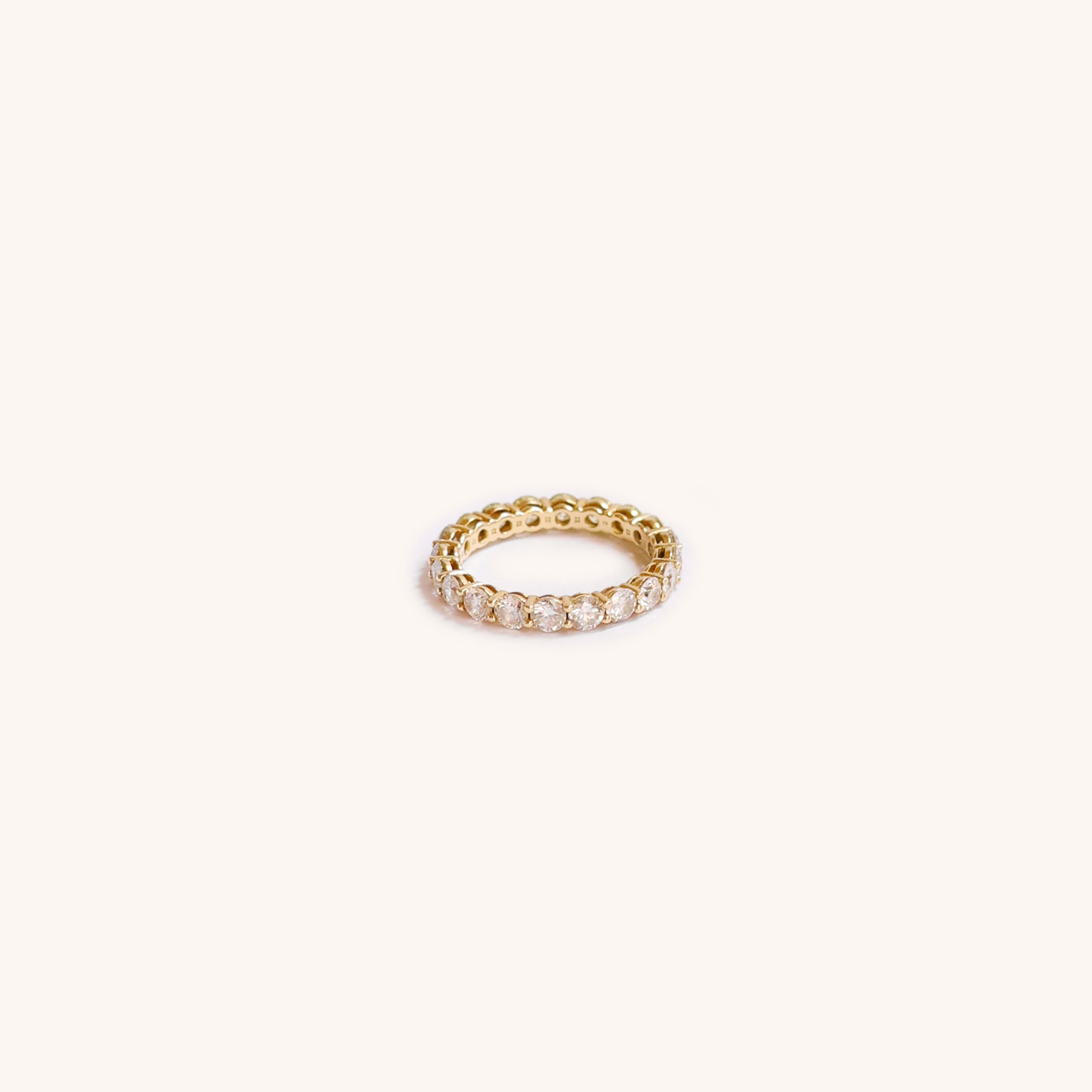 Gold ring with small diamonds around the band.
