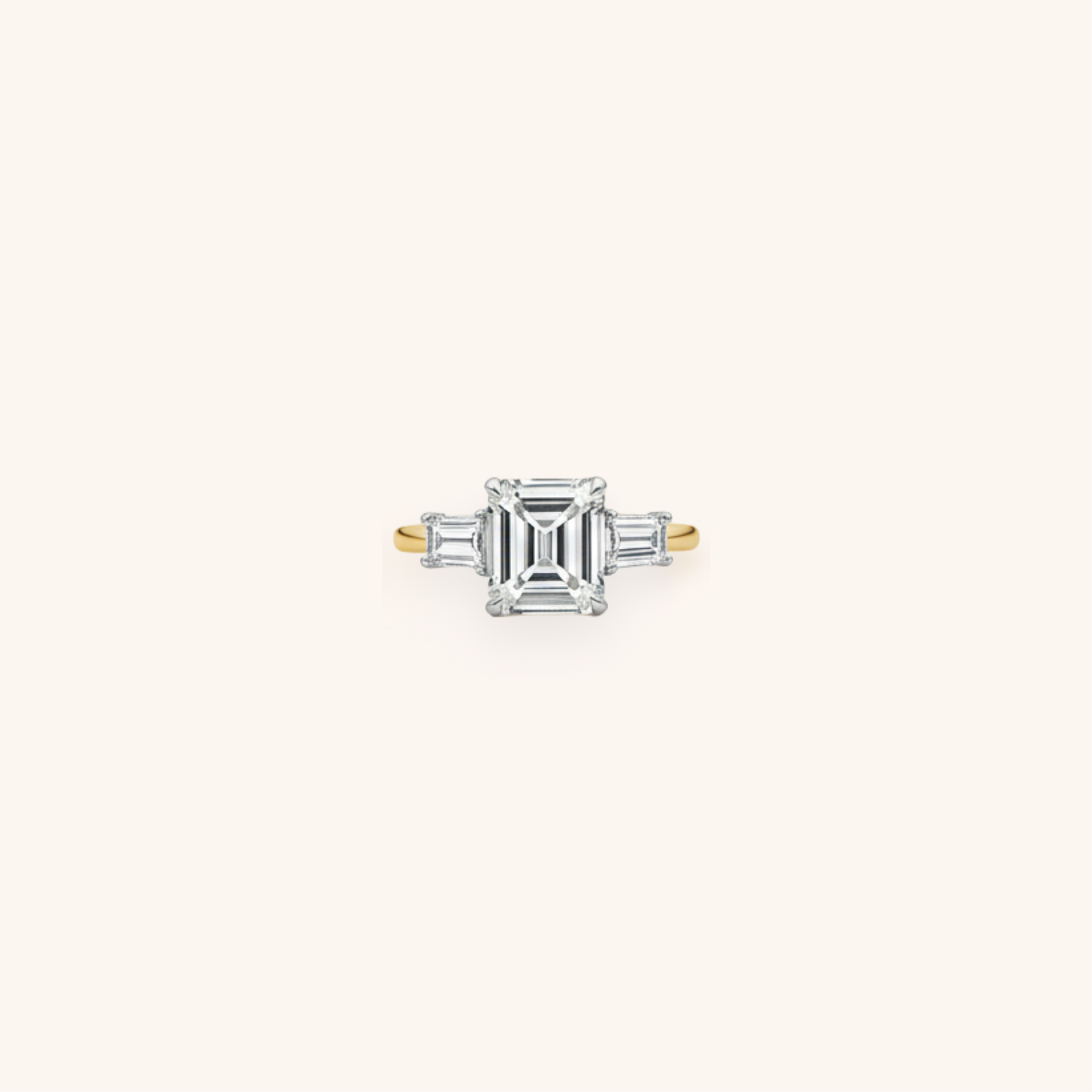 Diamond ring with a square-shaped center stone flanked by baguette diamonds on a gold band.