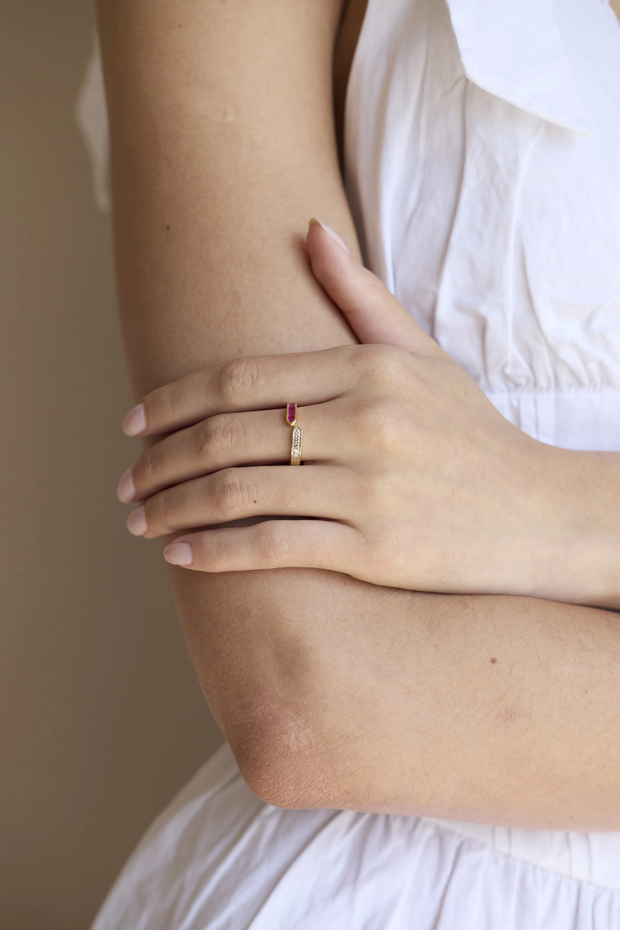 Model wearing 14K gold diamond and pink stone ring, romantic jewelry.