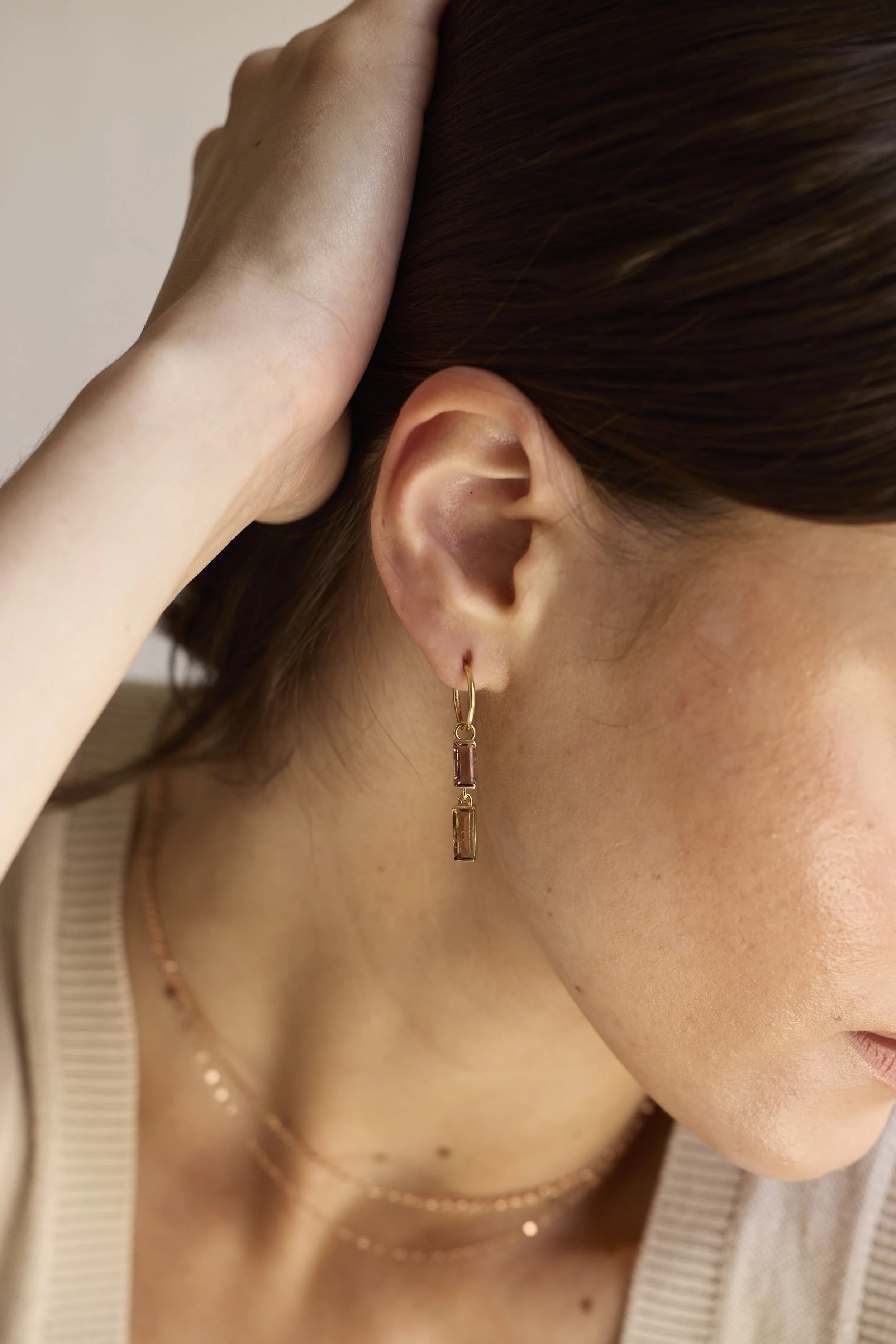 Close-up of twin pink tourmaline gemstones set in 14K gold, handmade luxury earrings with soft romantic hues.