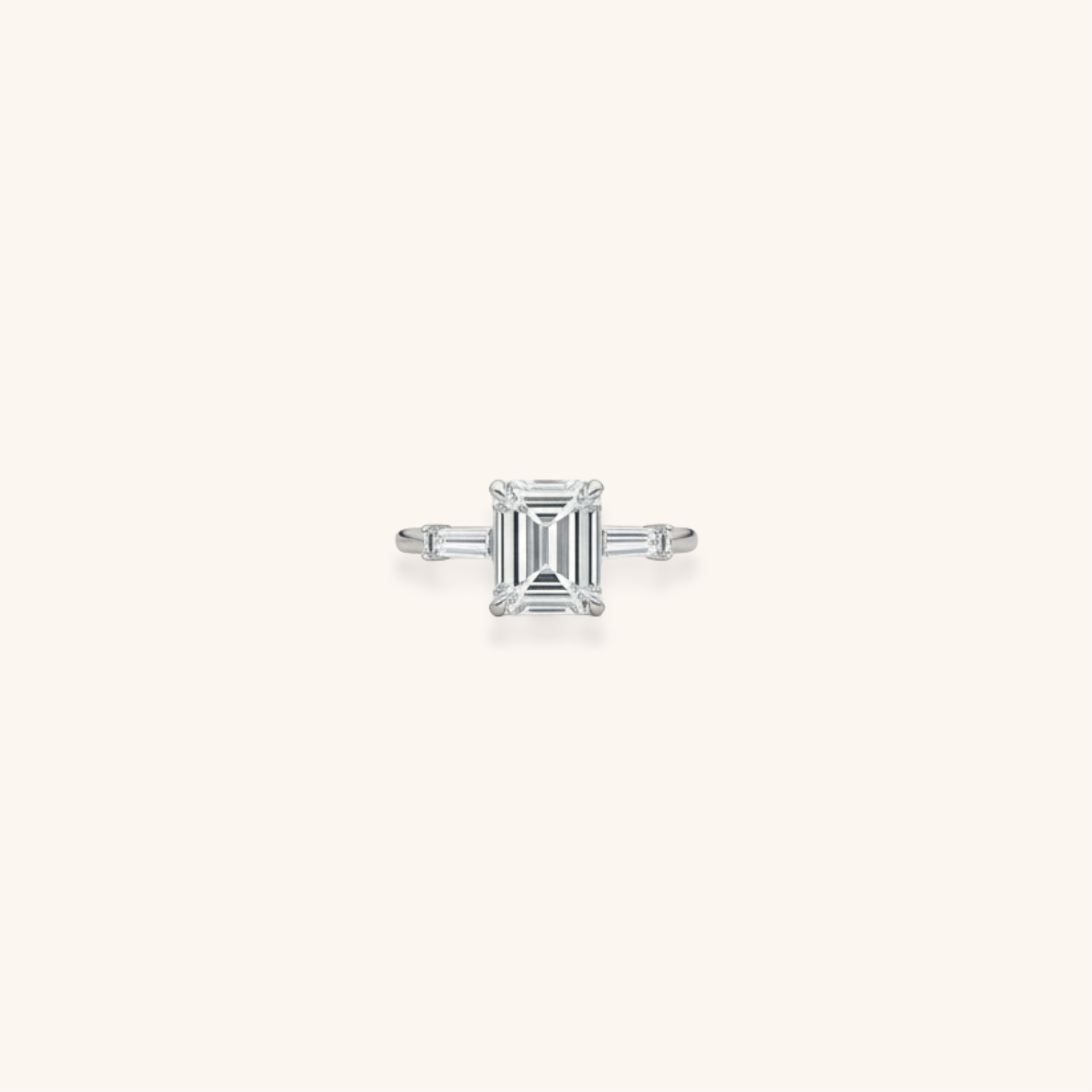 Elegant silver ring with an emerald-cut diamond centerpiece and side baguette diamonds