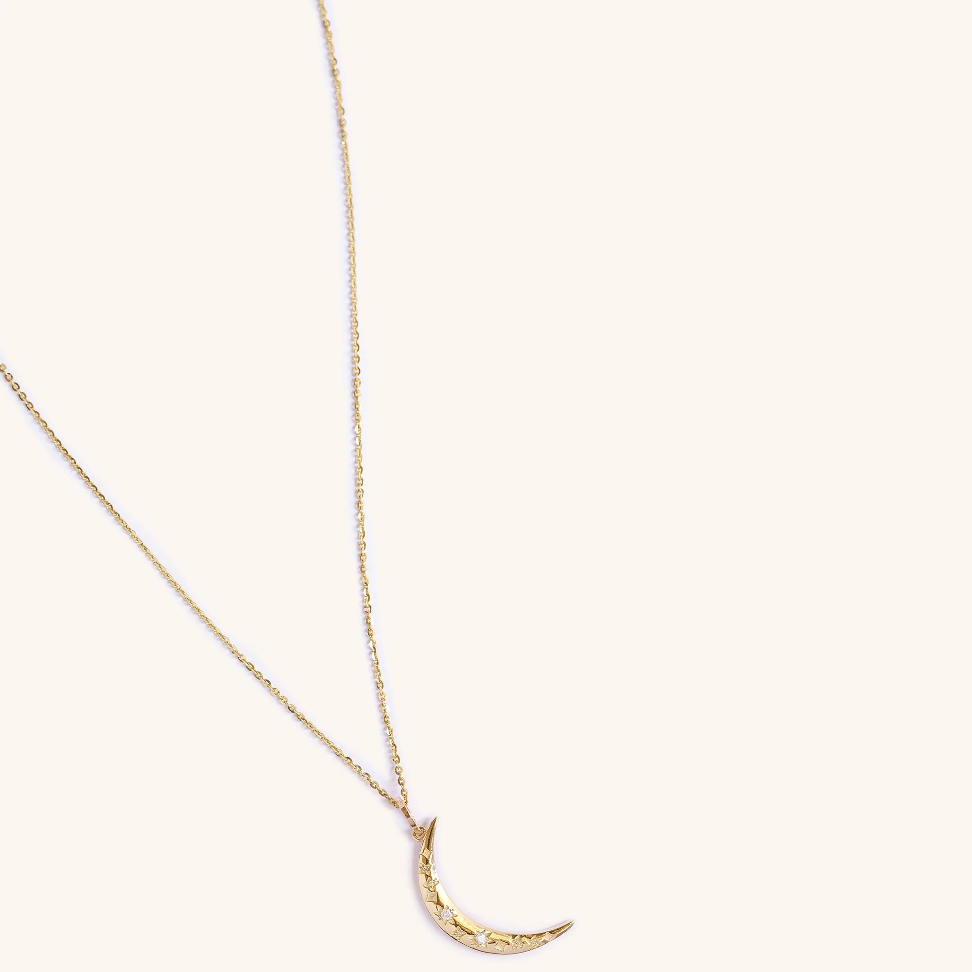 14K gold crescent moon pendant with diamonds, celestial jewelry by Zikr Fine Jewelry.