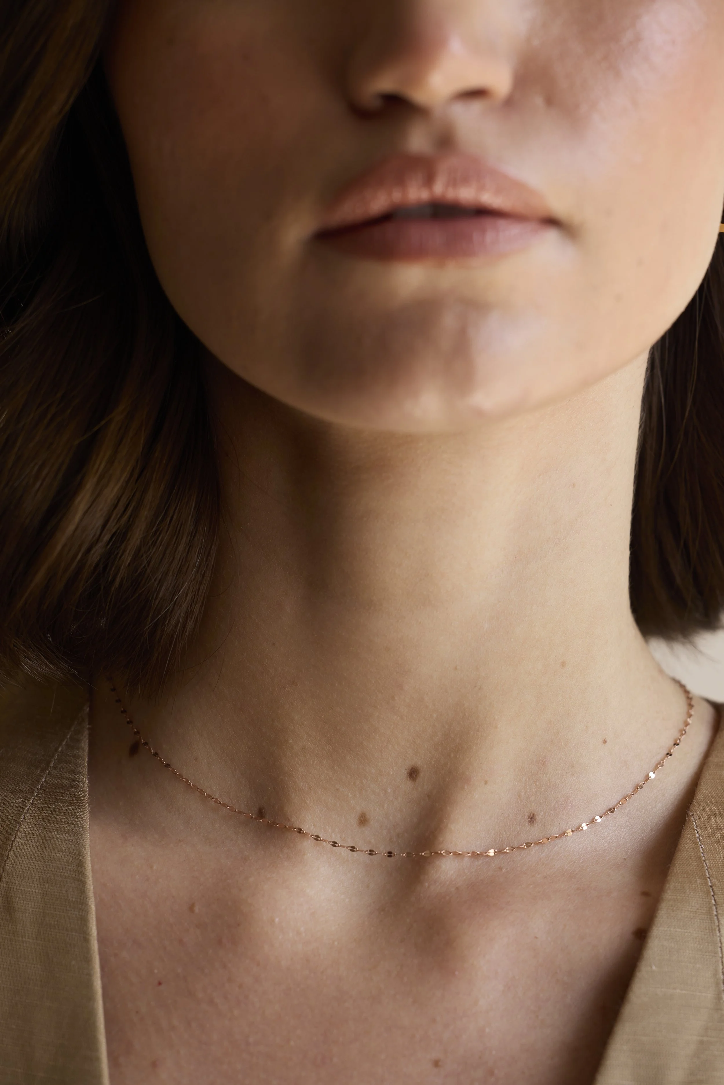 Model wearing 18K rose gold chain with pendant, elegant everyday luxury.