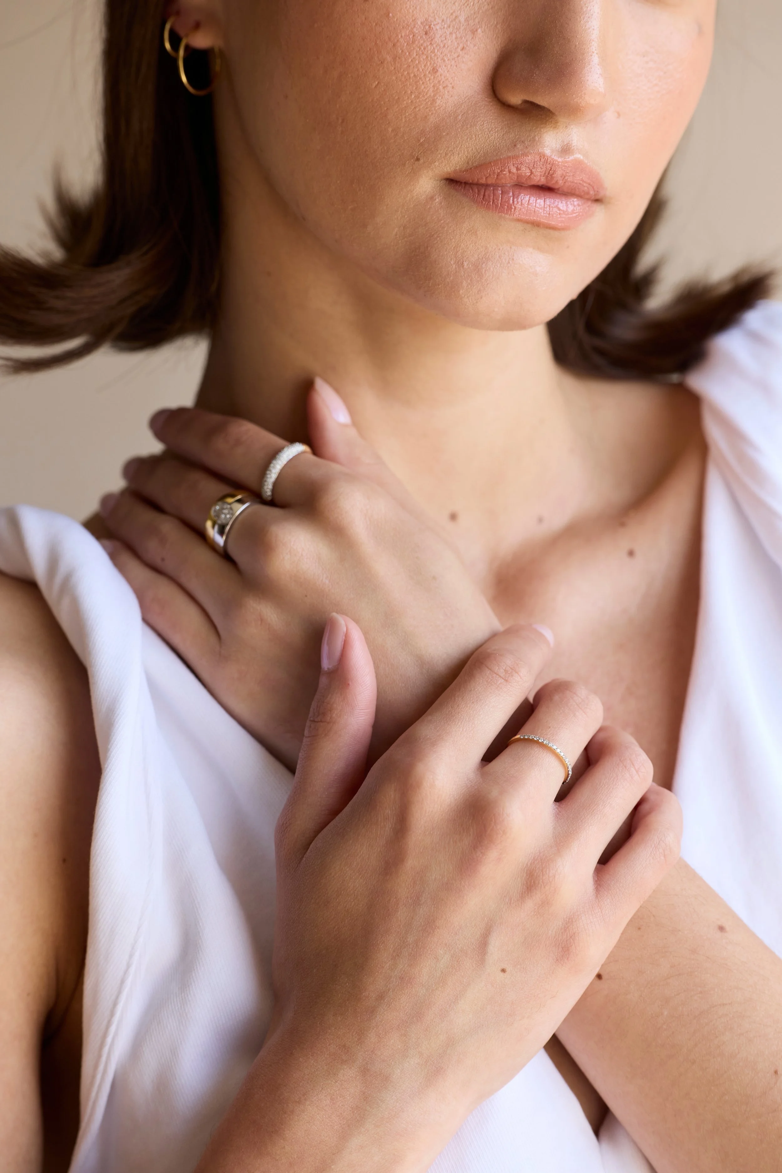 Model wearing gold diamond eternity band, classic wedding ring style.