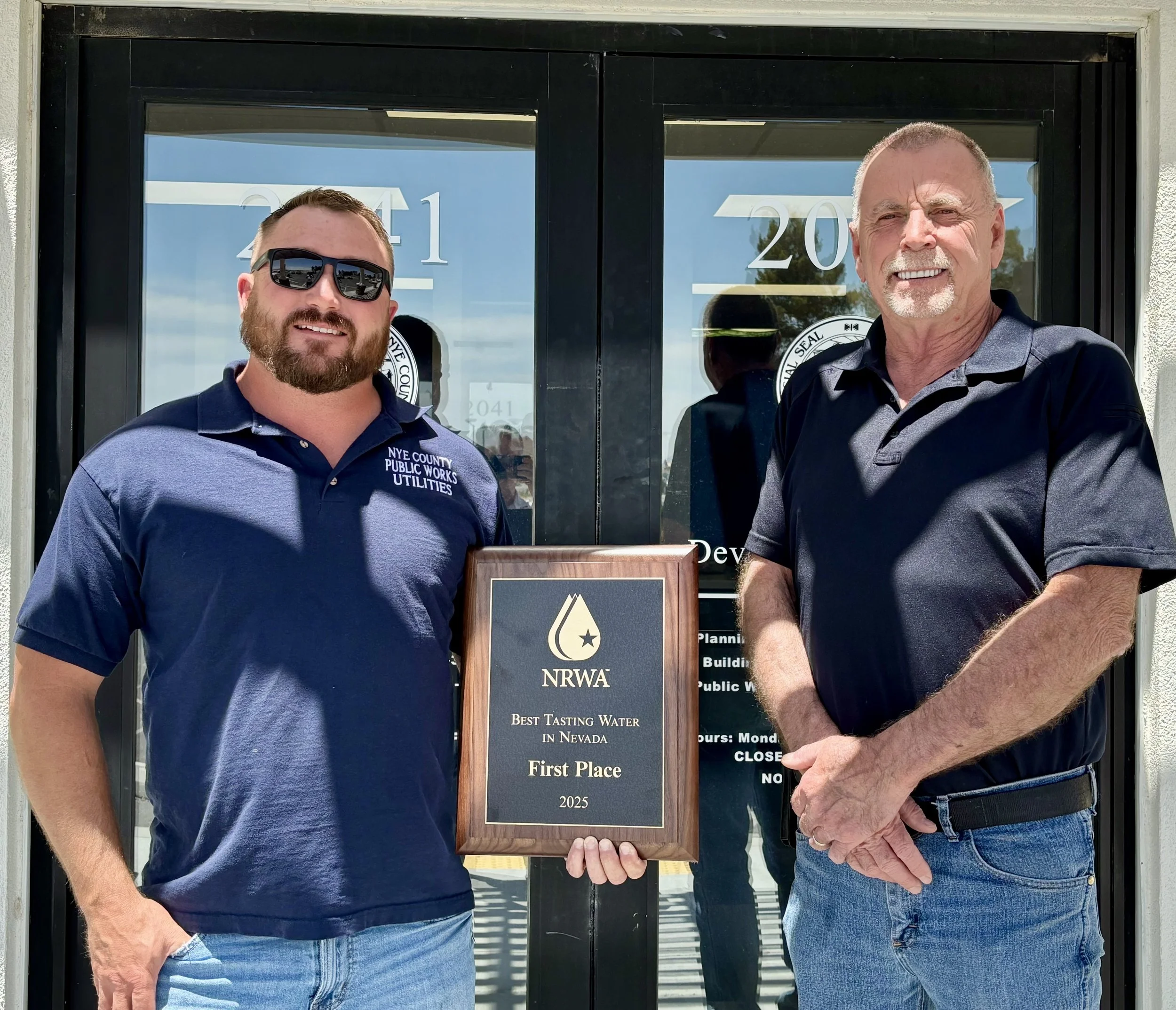 Travis Smith and Darrin Tuck with Nye County Complex accept the award for best-tasting water.