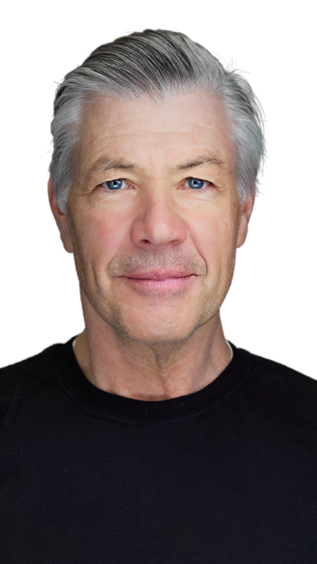 Close-up of an older man with silver hair and blue eyes, wearing a black shirt, looking directly at the camera.