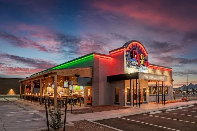 Ojos Locos Restaurant with Bright Neon Colors and Restaurant Tables on a patio