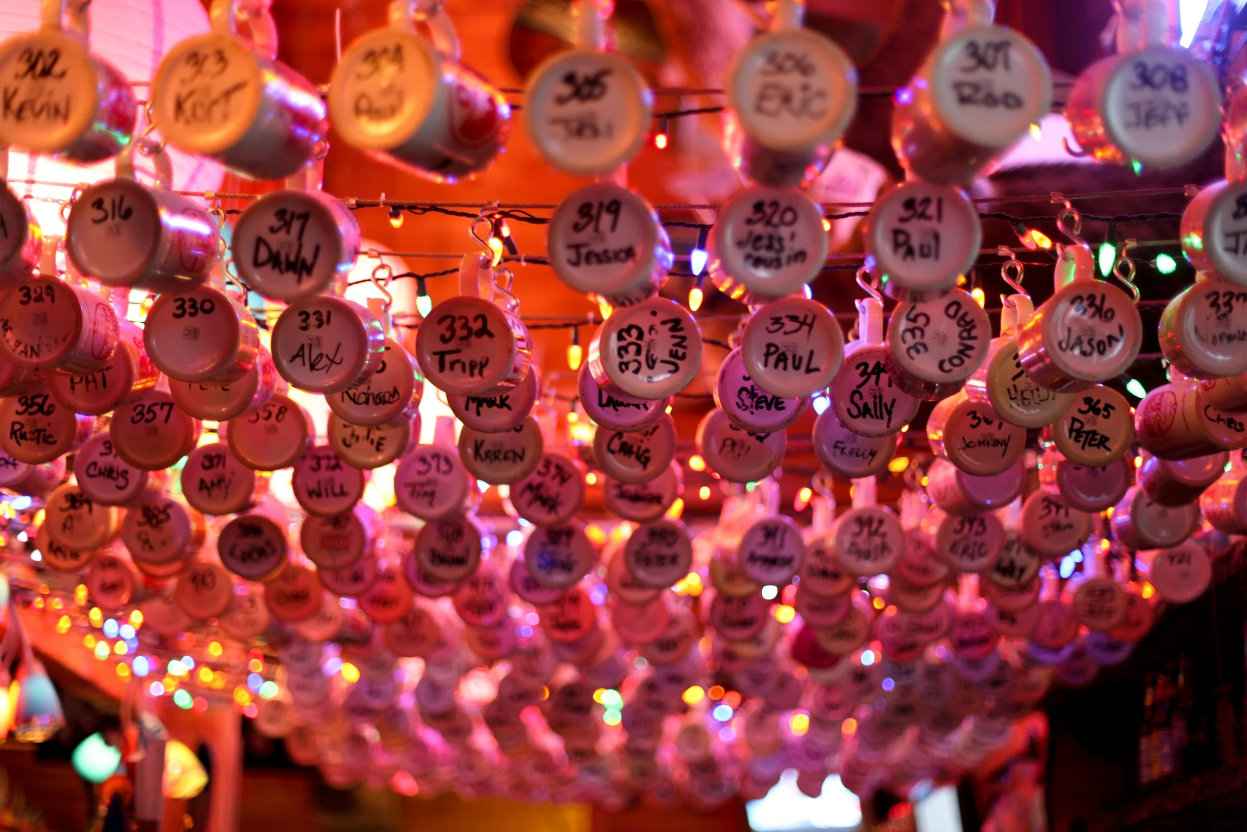 Restaurant mug club member mugs hanging above a bar