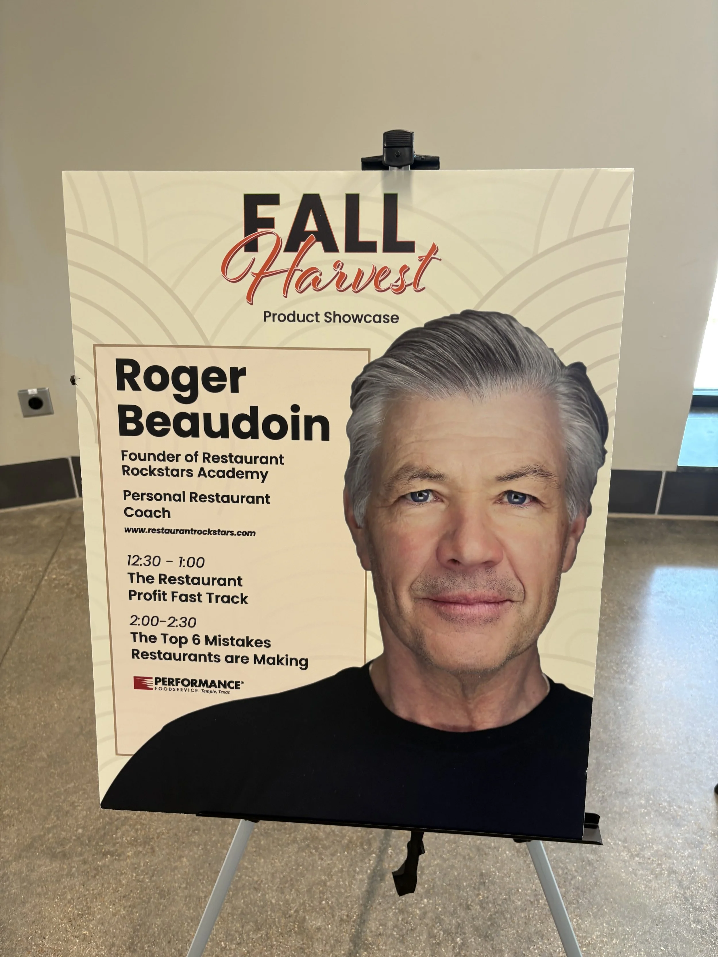 Poster featuring a man with gray hair and blue eyes, advertising a fall harvest product showcase and a seminar schedule, with a white background and decorative gold lines.