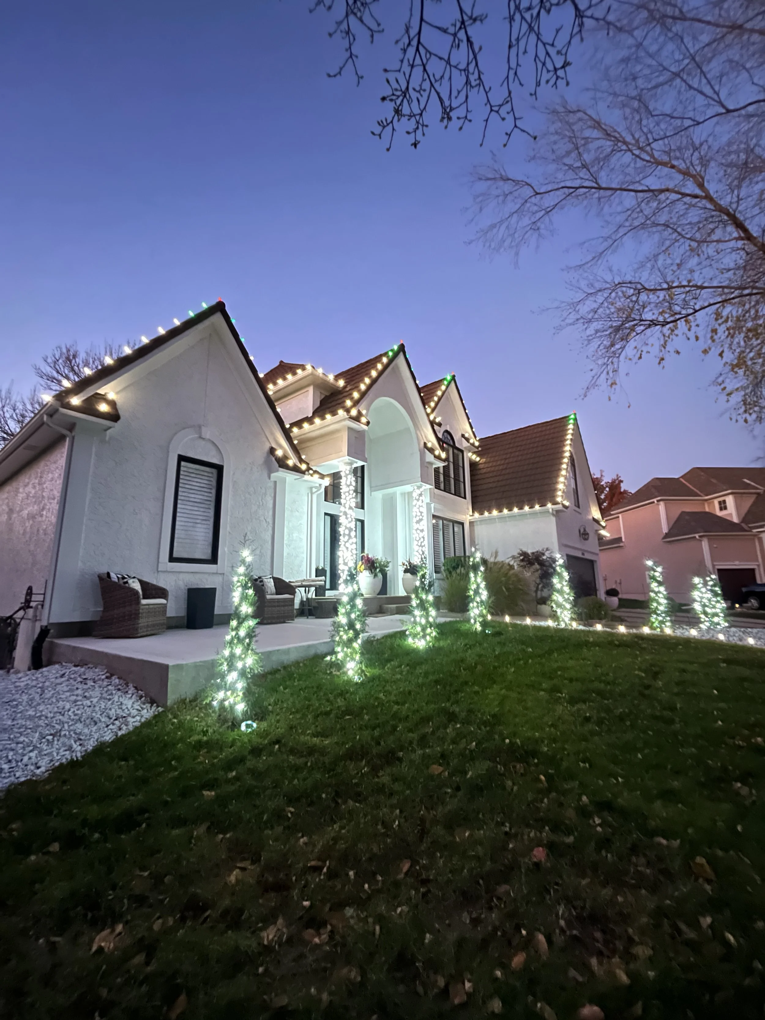 christmas light display with roofline and bushes in mission hills kansas