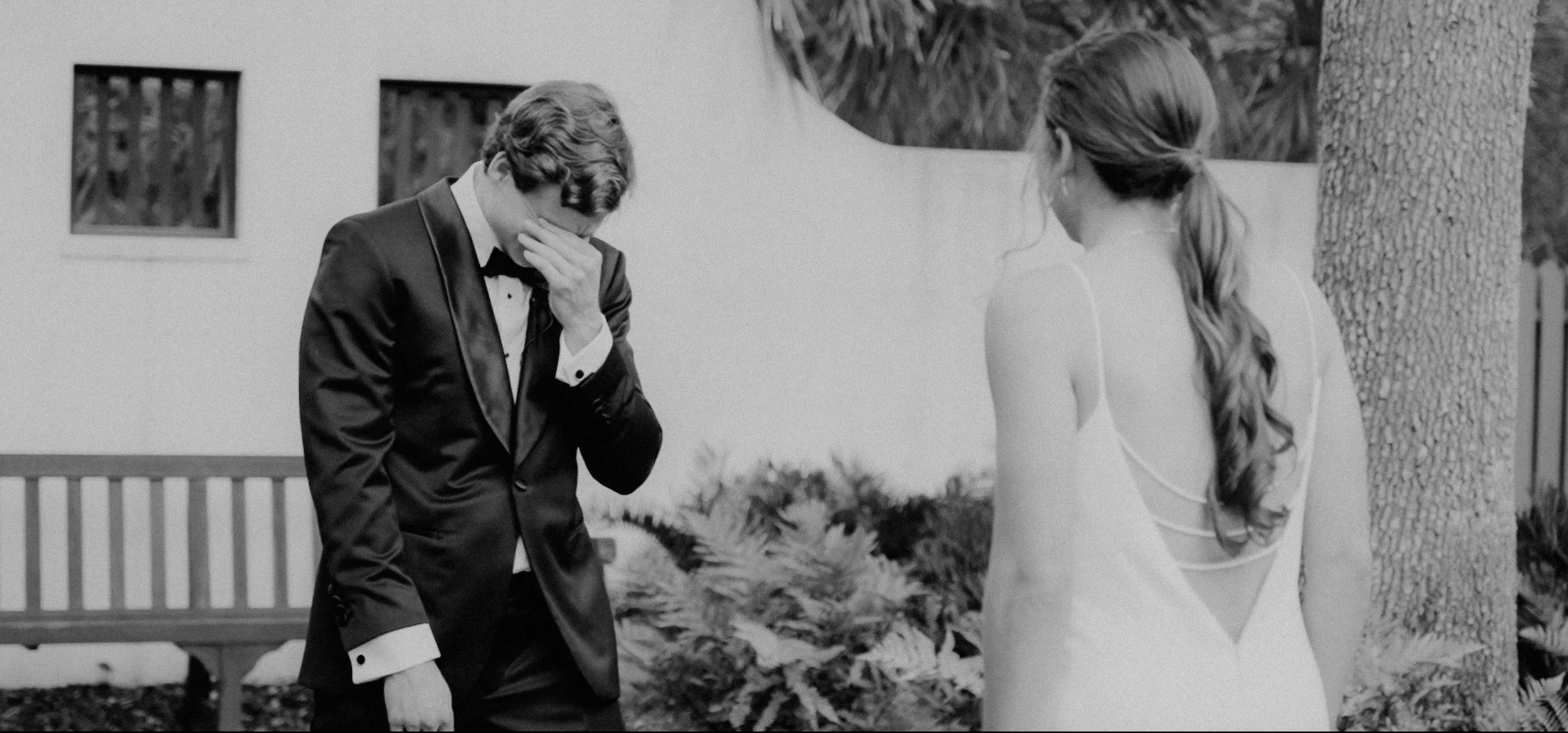 Emotional groom in tears during wedding ceremony with bride .