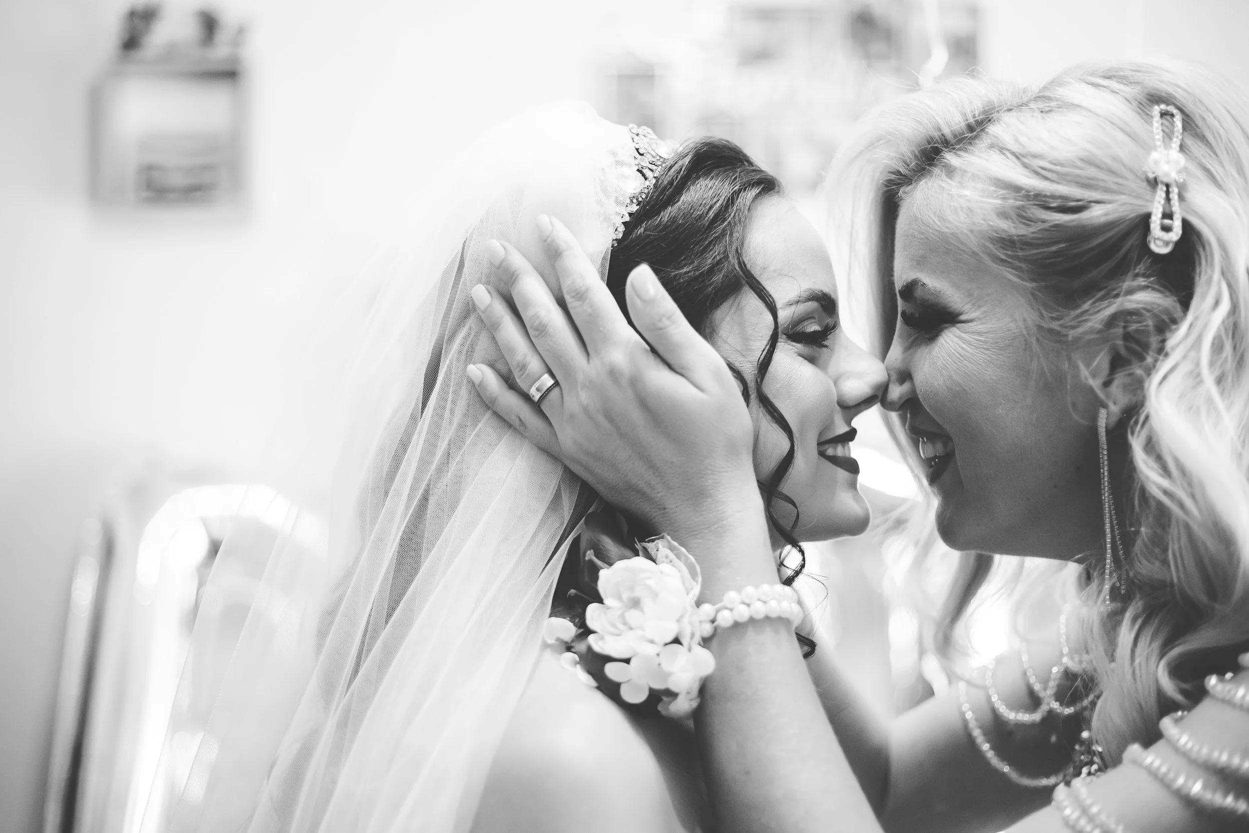 Bride sharing a close moment with her mother during her wedding