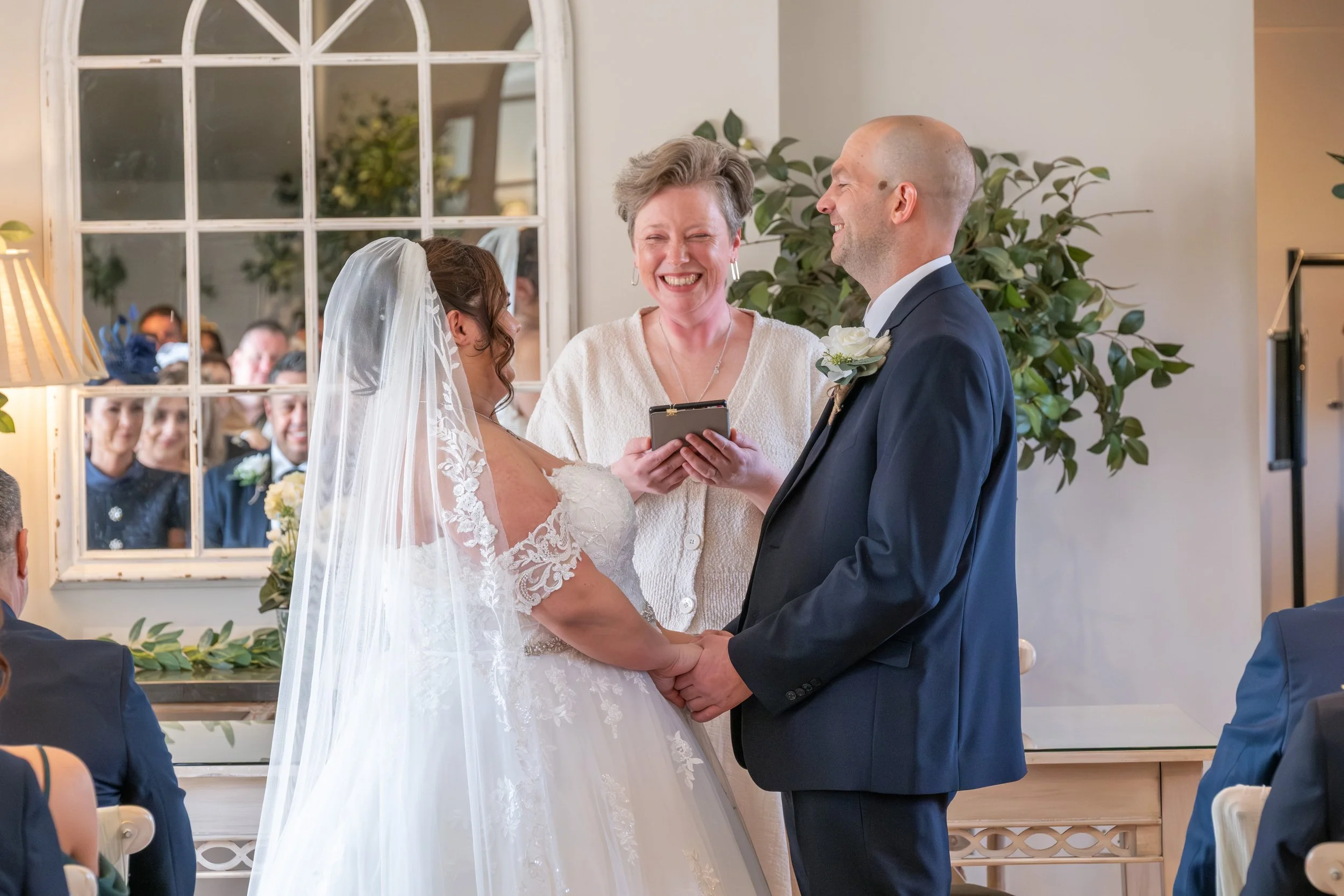 Wedding celebrant Sinéad Laffan leading a ceremony with a couple and their guests