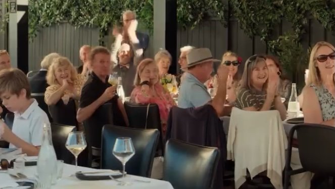 Private restaurant patio filled with guests for Amber and Chris’s surprise wedding ceremony