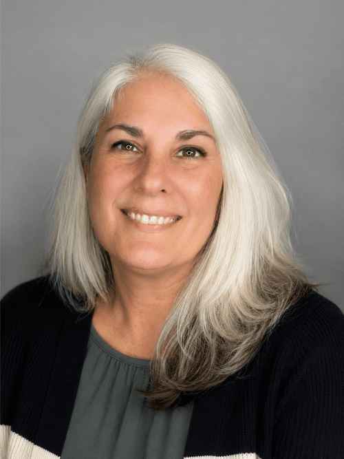 Professional headshot of a woman photographed on a clean white background
