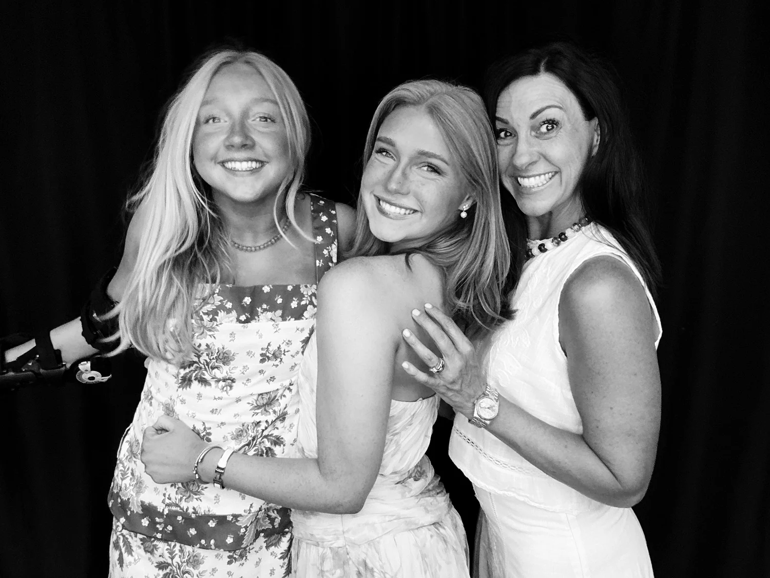 Family posing for a black and white photo booth picture