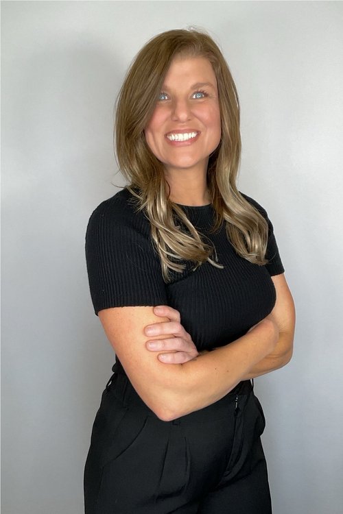 Professional headshot of a woman photographed on a clean white background