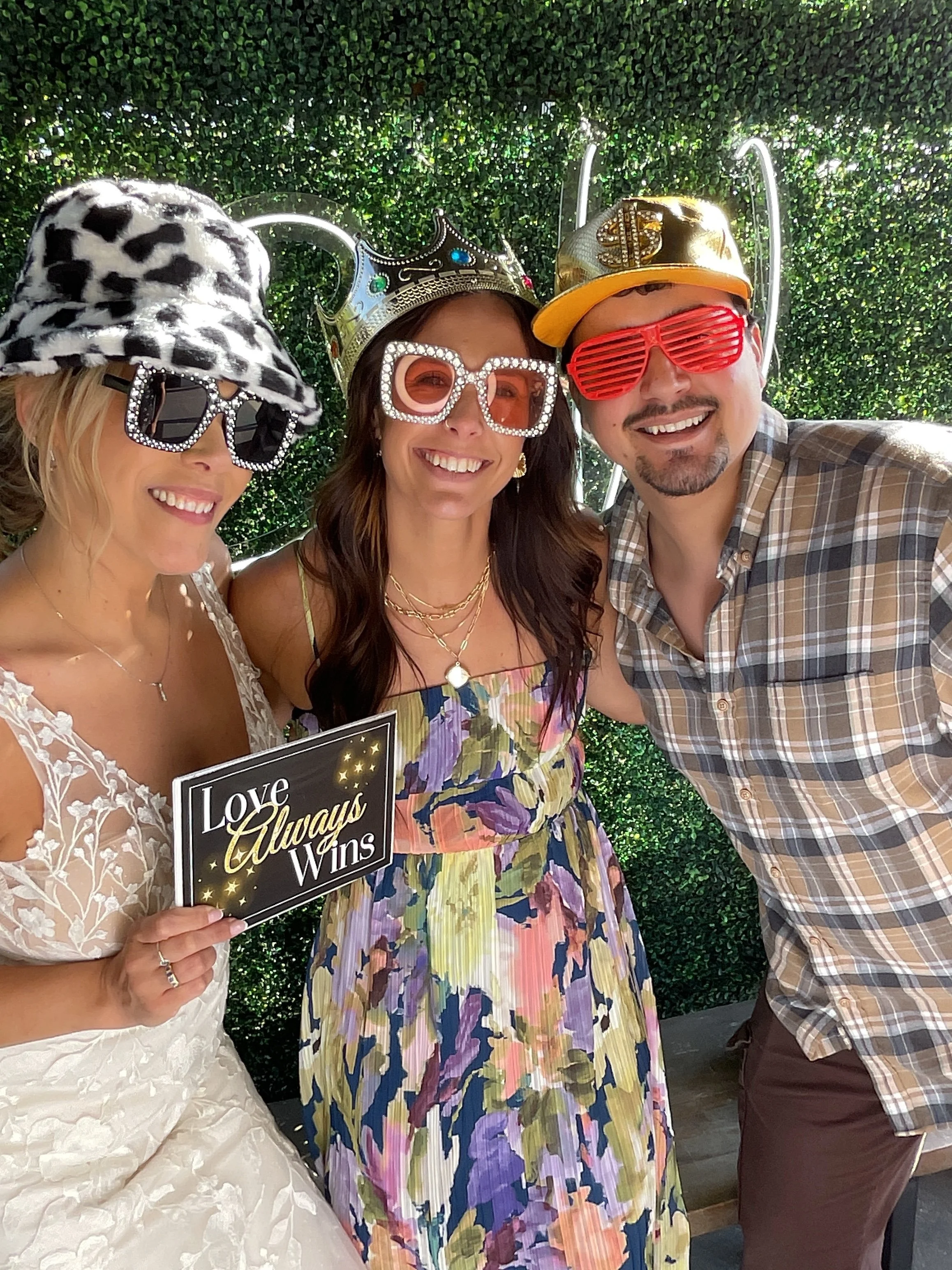 Wedding guests posing together at a CheesyPix photo booth