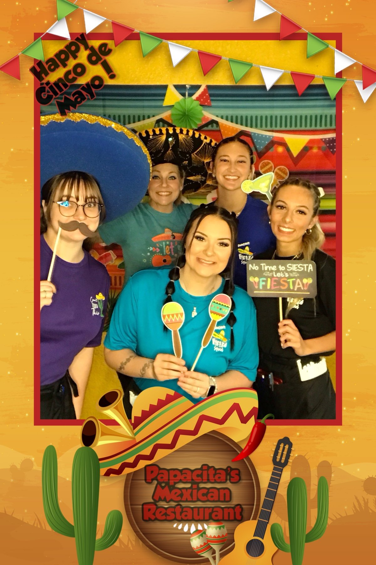 Group of people celebrating Cinco de Mayo at Papacita's Mexican Restaurant, holding festive props like mustaches and maracas, with a colorful background and decorative elements like cacti and guitars.