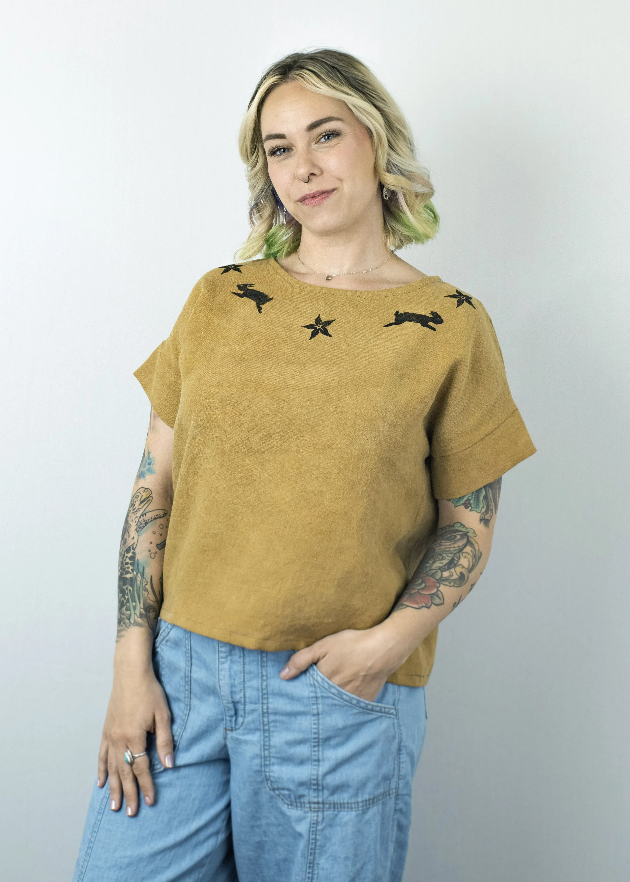 100% Linen Tee, natural dyed. Original art, hand-carved lino block prints. 2025.