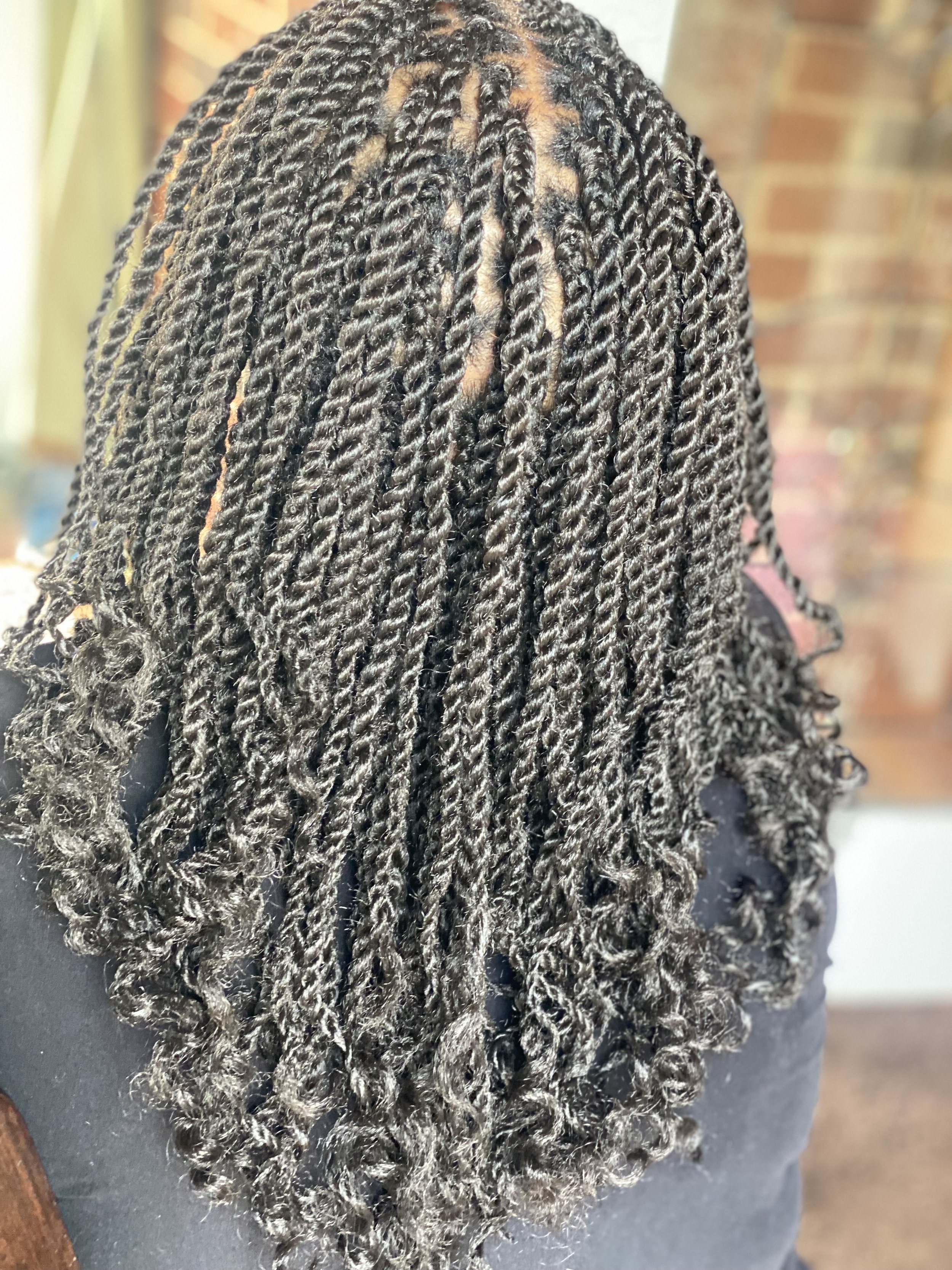Close-up of dark hair with small, neat twists.