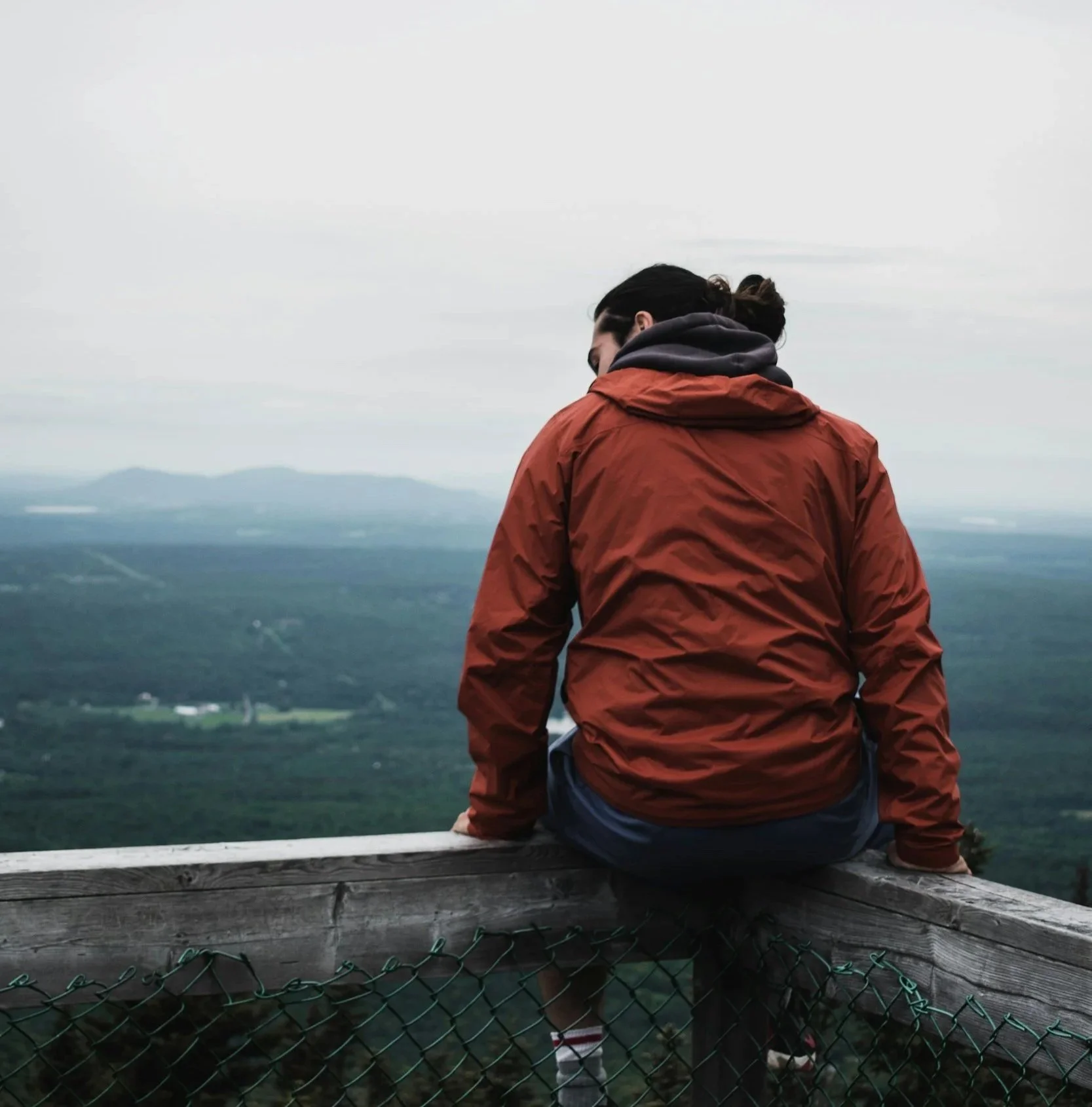 Person reflecting outdoors while exploring EFT therapy for emotional healing