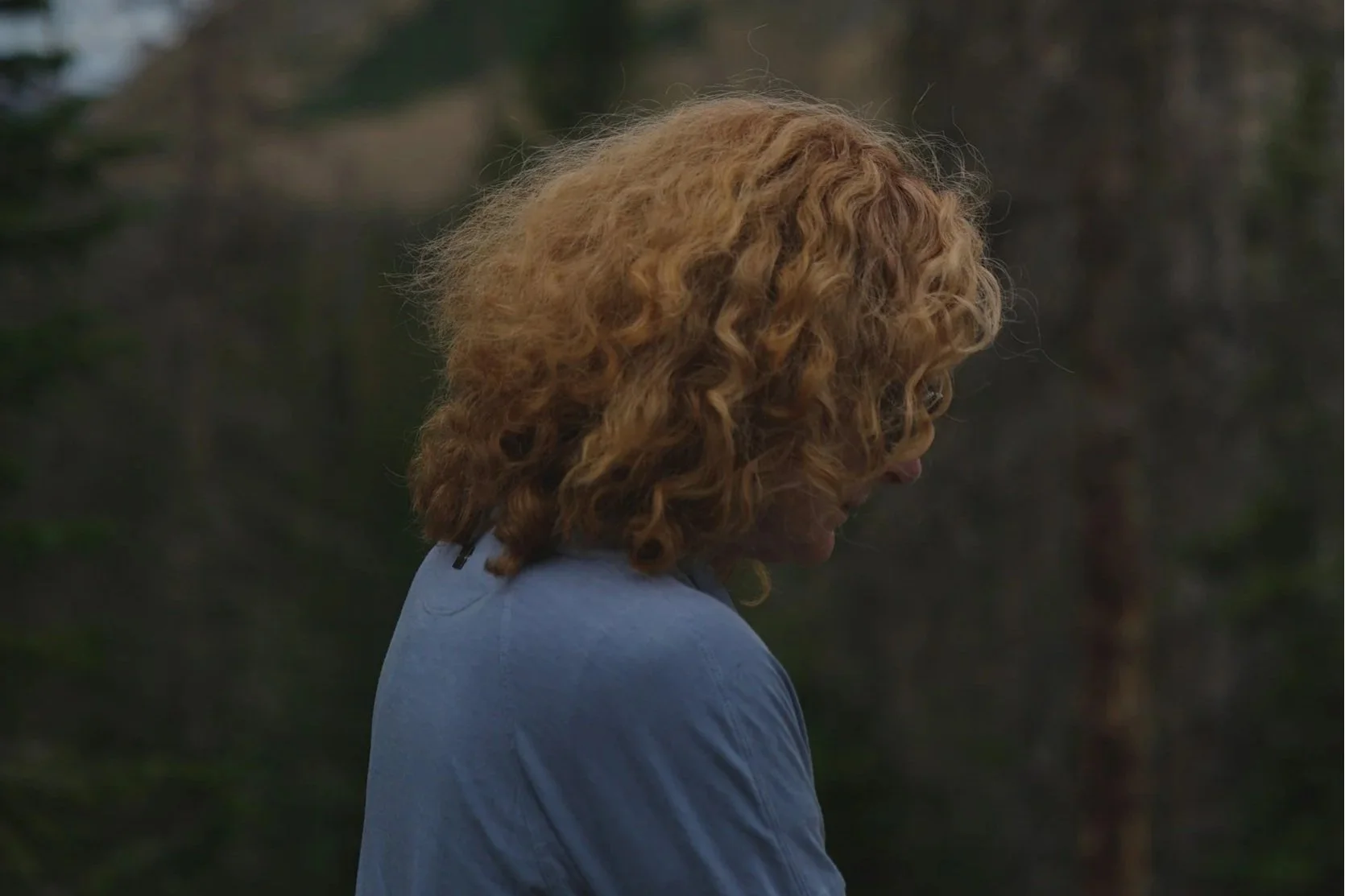 Person sitting alone outdoors reflecting on trauma and PTSD therapy support in California