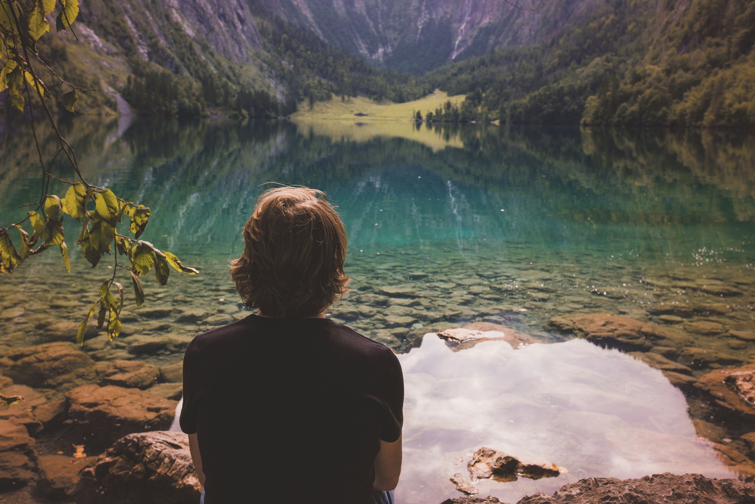 Woman practicing emotional freedom technique tapping in a peaceful outdoor setting