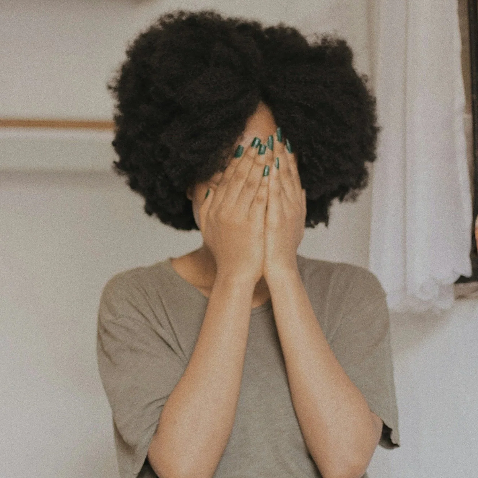 Woman covering her face while experiencing stress and anxiety, representing anxiety therapy support in California